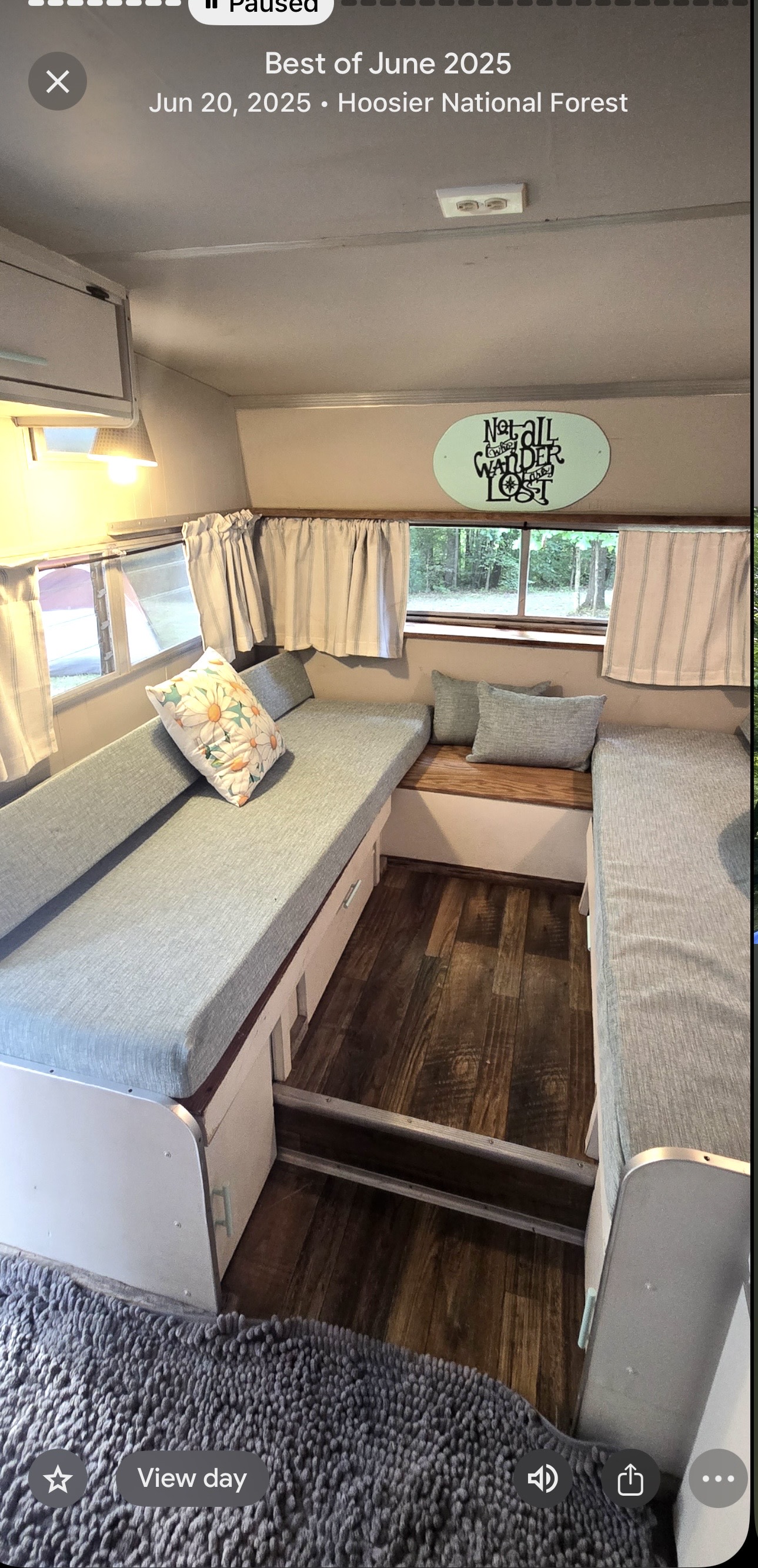 Cozy RV rental interior in Hoosier National Forest. Comfy benches, forest views & "wander" sign for June 20, 2025 trip.. Shasta Loflyte 1600 1969