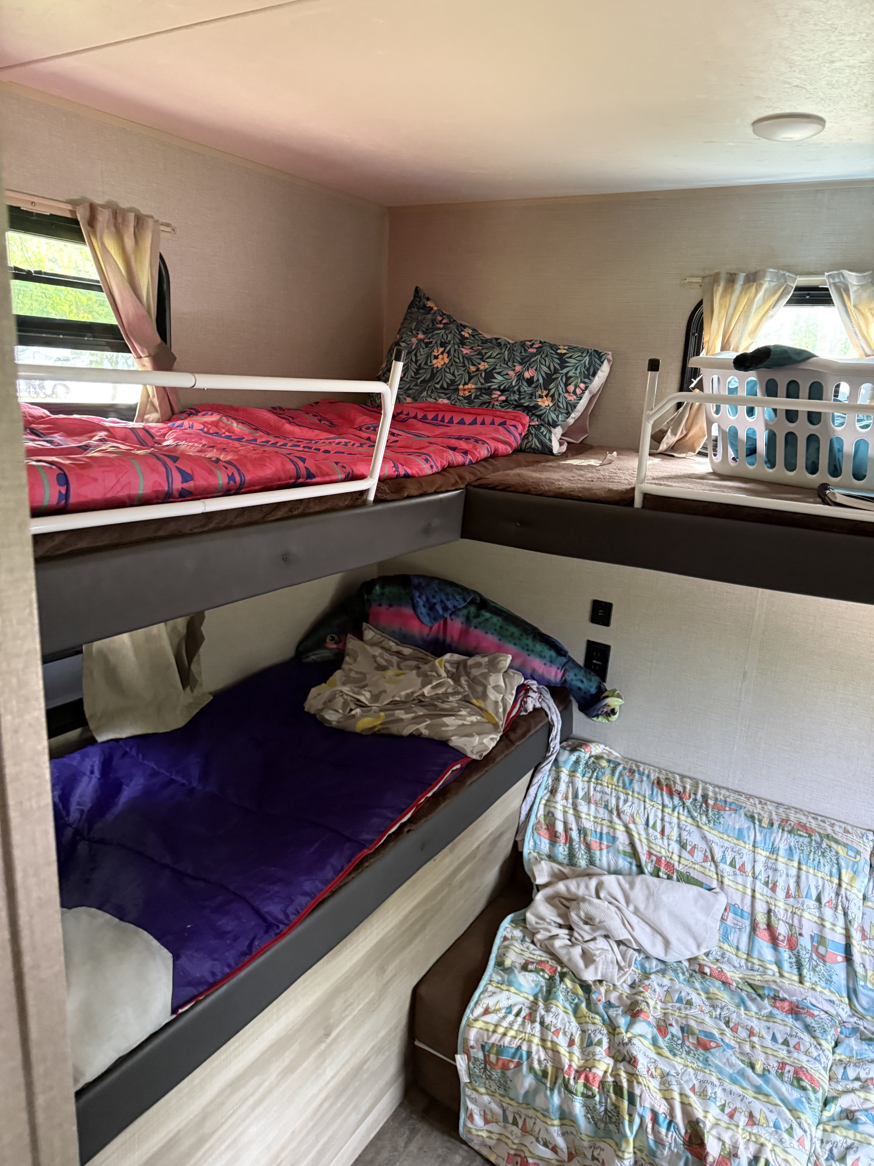 Cozy RV rental interior with bright bunk beds, a lower sofa, and comfy bedding for family trips.. Forest River Coachmen Catalina Legacy 2021