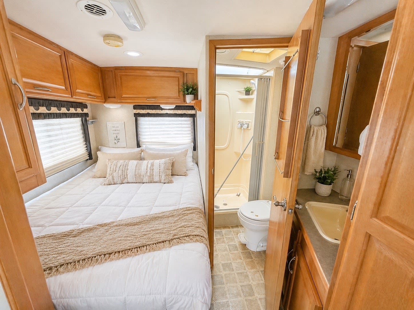 This cozy RV rental features a comfortable bedroom with a full bed and overhead storage, plus a compact bathroom with shower and sink.. Winnebago Aspect 2006