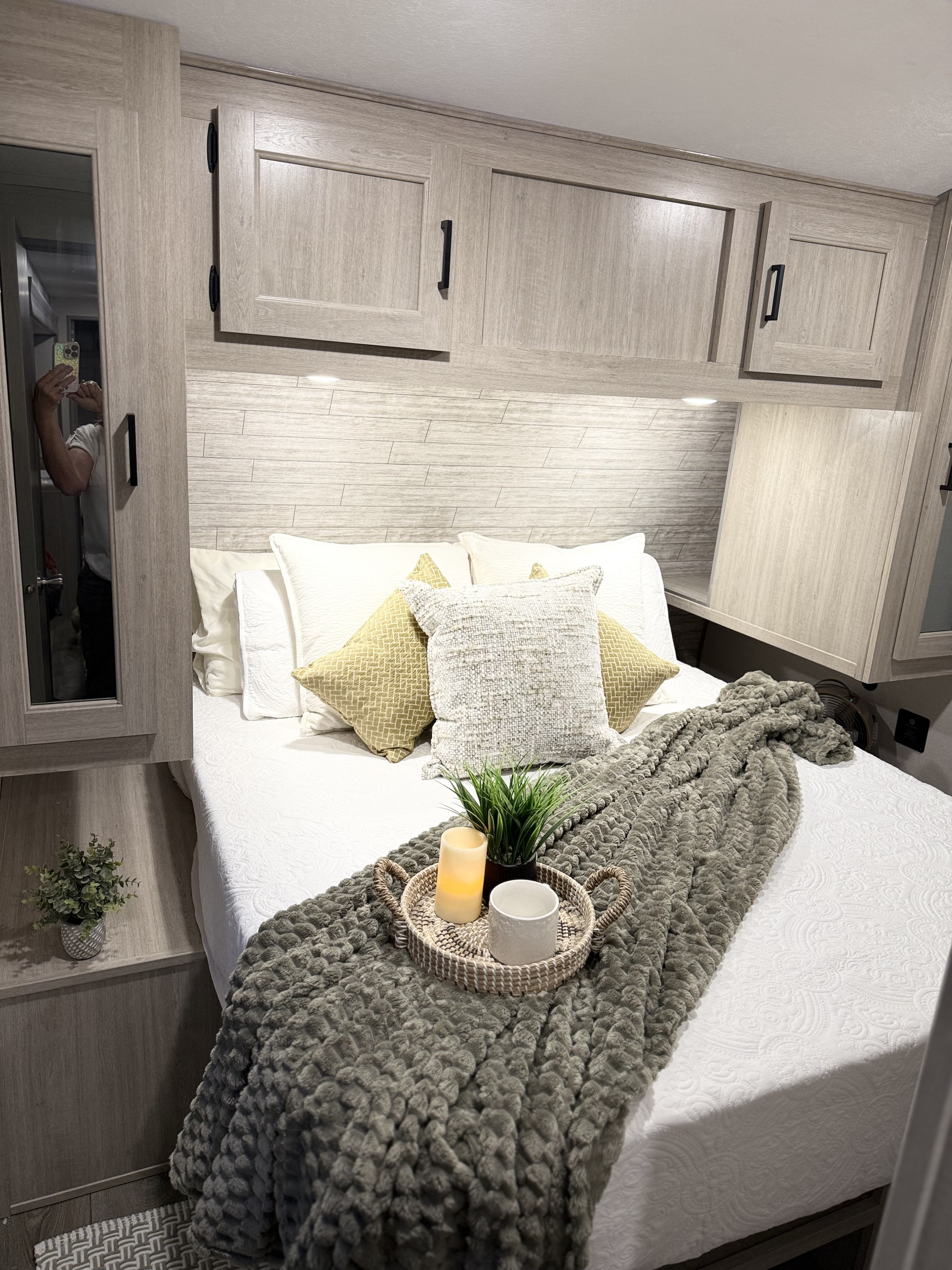 Comfortable RV rental bedroom with stylish decor, warm lighting, ample storage, and a cozy bed.. Catalina 293TQBSCK 2026