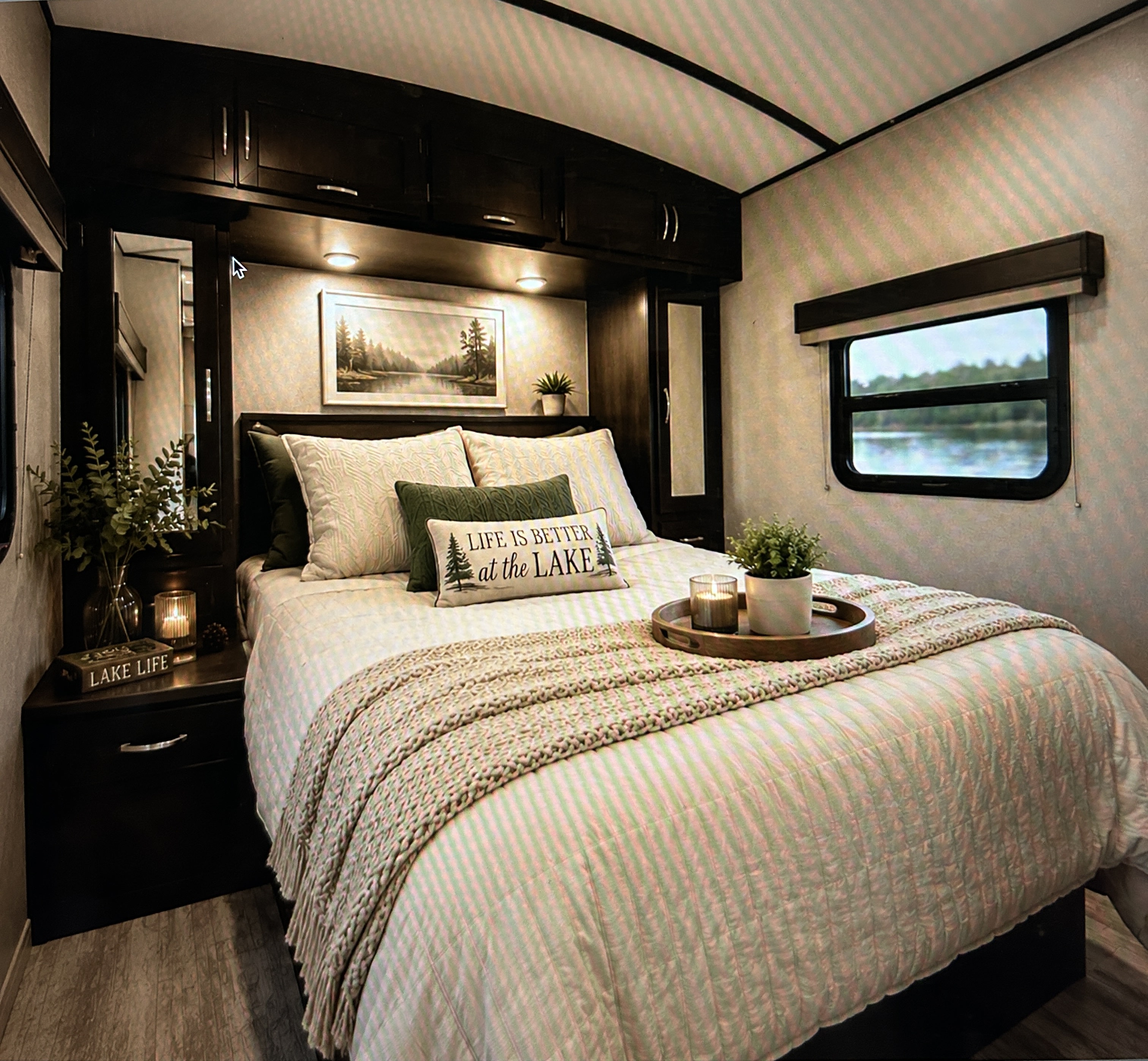 Cozy RV rental bedroom featuring a lake view window, inviting bedding, and rustic decor. Perfect for your next adventure.. Grand Design Imagine 2019