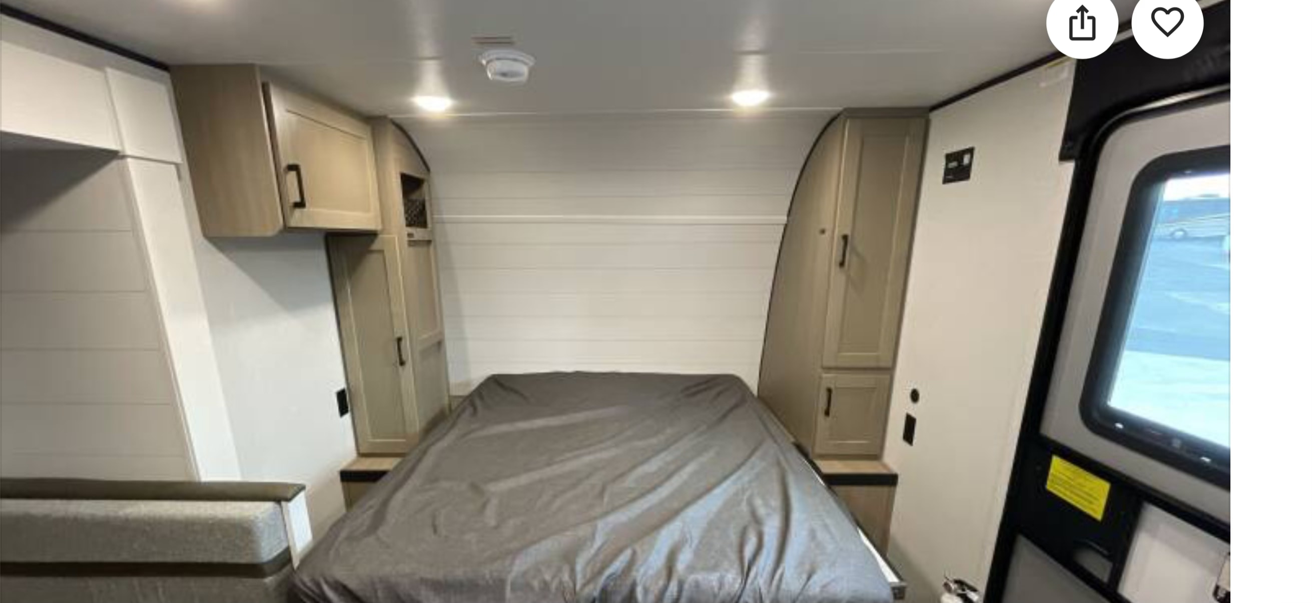 Inside this RV rental, a compact bedroom with a full-size bed, overhead storage, and light-colored modern finishes for a comfortable stay.. Highland Ridge RV Colt 2026
