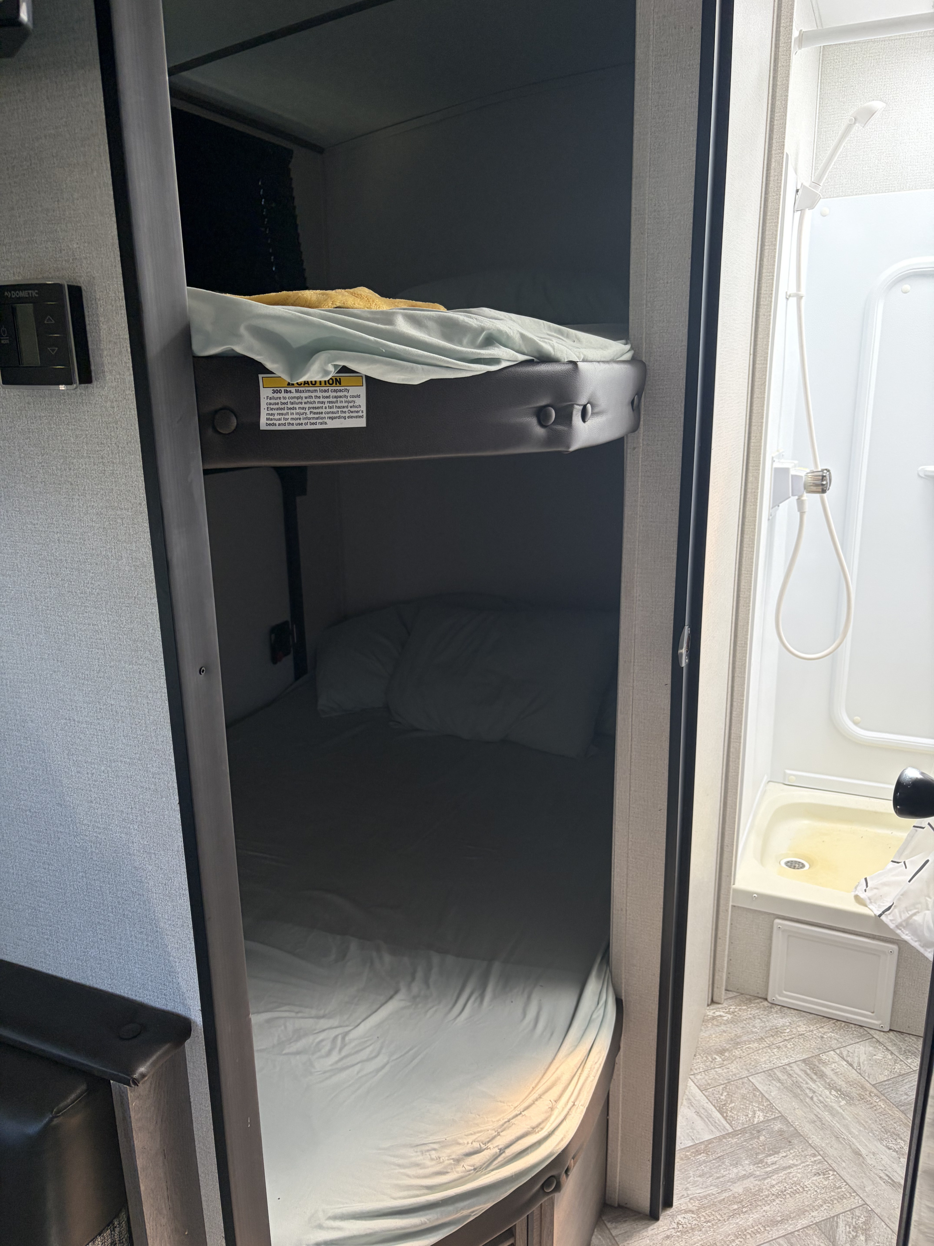 This rv rental offers comfortable bunk beds (max 300 lbs) next to a compact shower, making the most of the space.. Keystone RV Springdale 2021