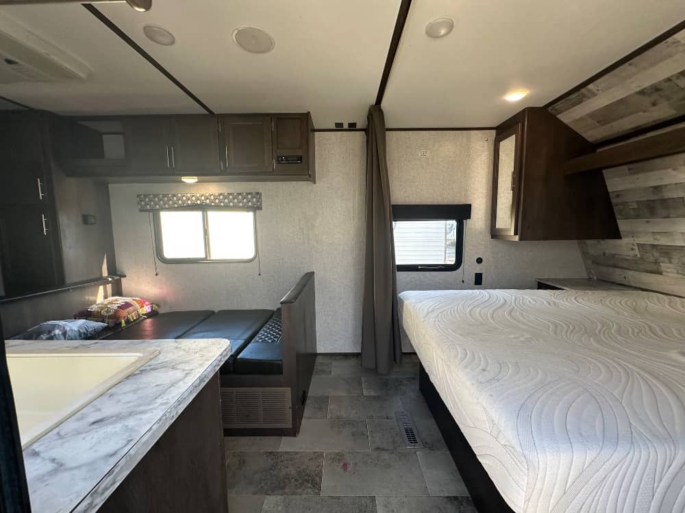 RV rental interior featuring a sleeping area, convertible dining bunk, and kitchenette. Ideal for travel.. Dutchmen Coleman Lantern LT 2020
