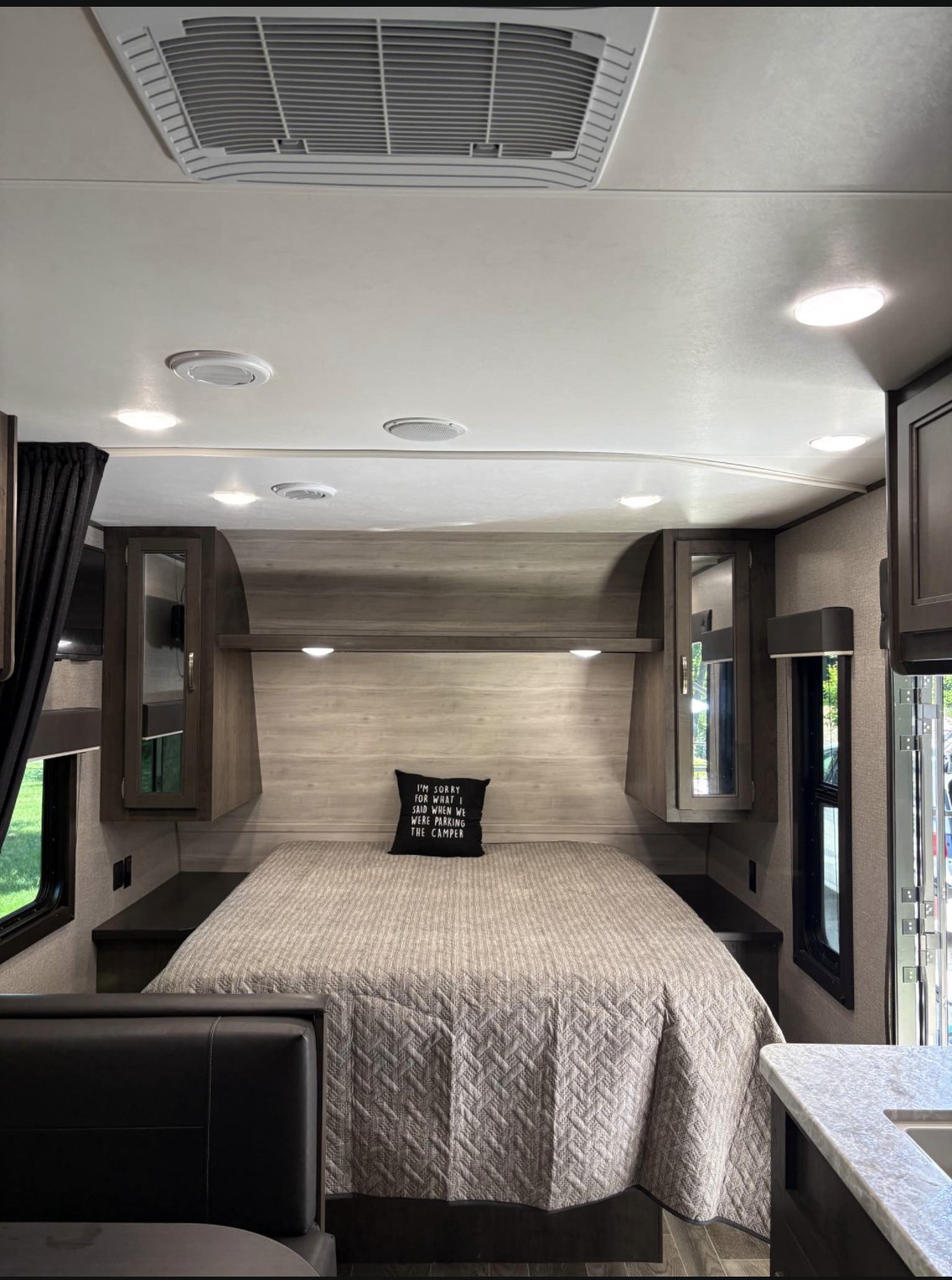 Cozy RV rental bedroom featuring a comfortable bed, convenient overhead storage, and bright ceiling lights for relaxing travel.. Jayco Jay Flight SLX 2021