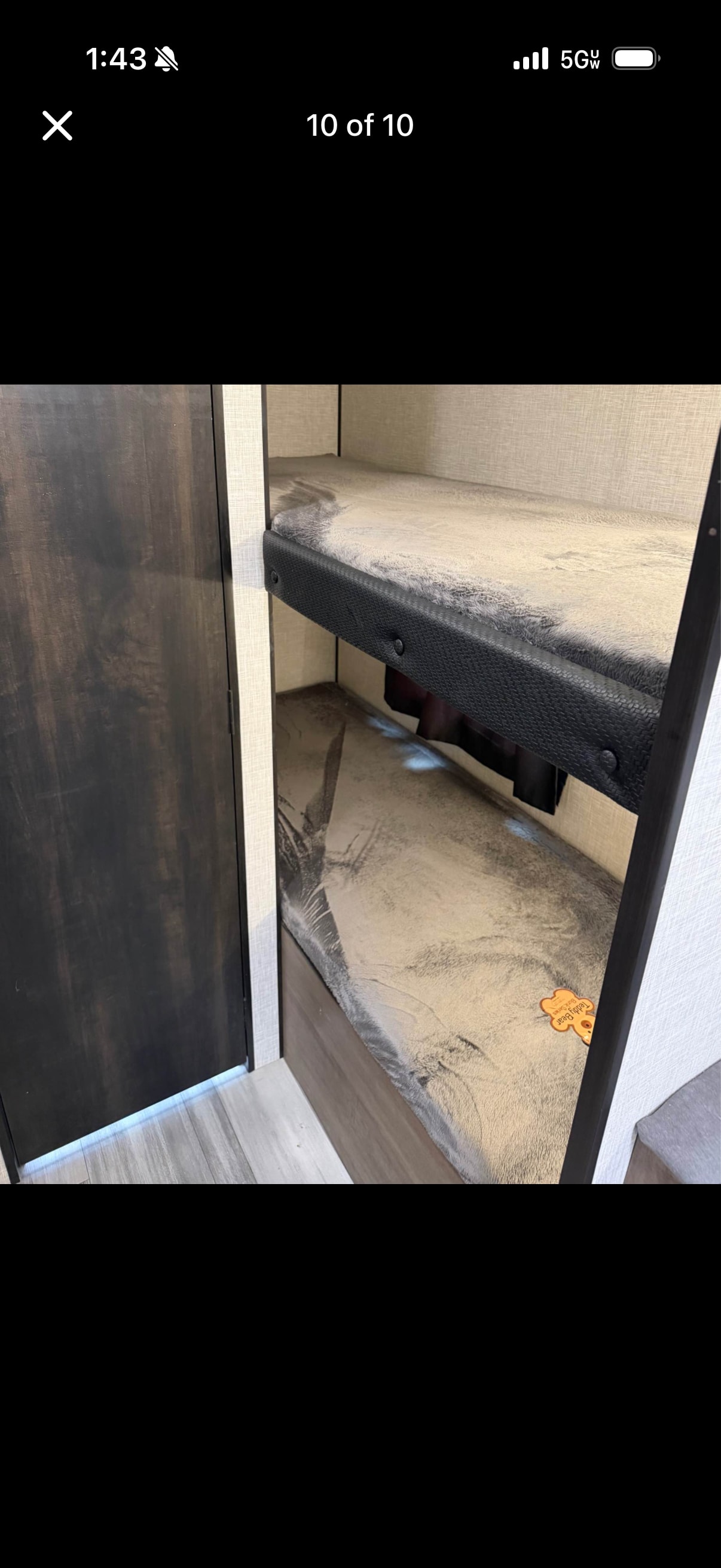 RV rental: cozy bunk beds with soft, grey bedding, featuring a 'Teddy Bear' tag. Ideal for comfortable travel.. Jayco Jay Flight SLX 2024