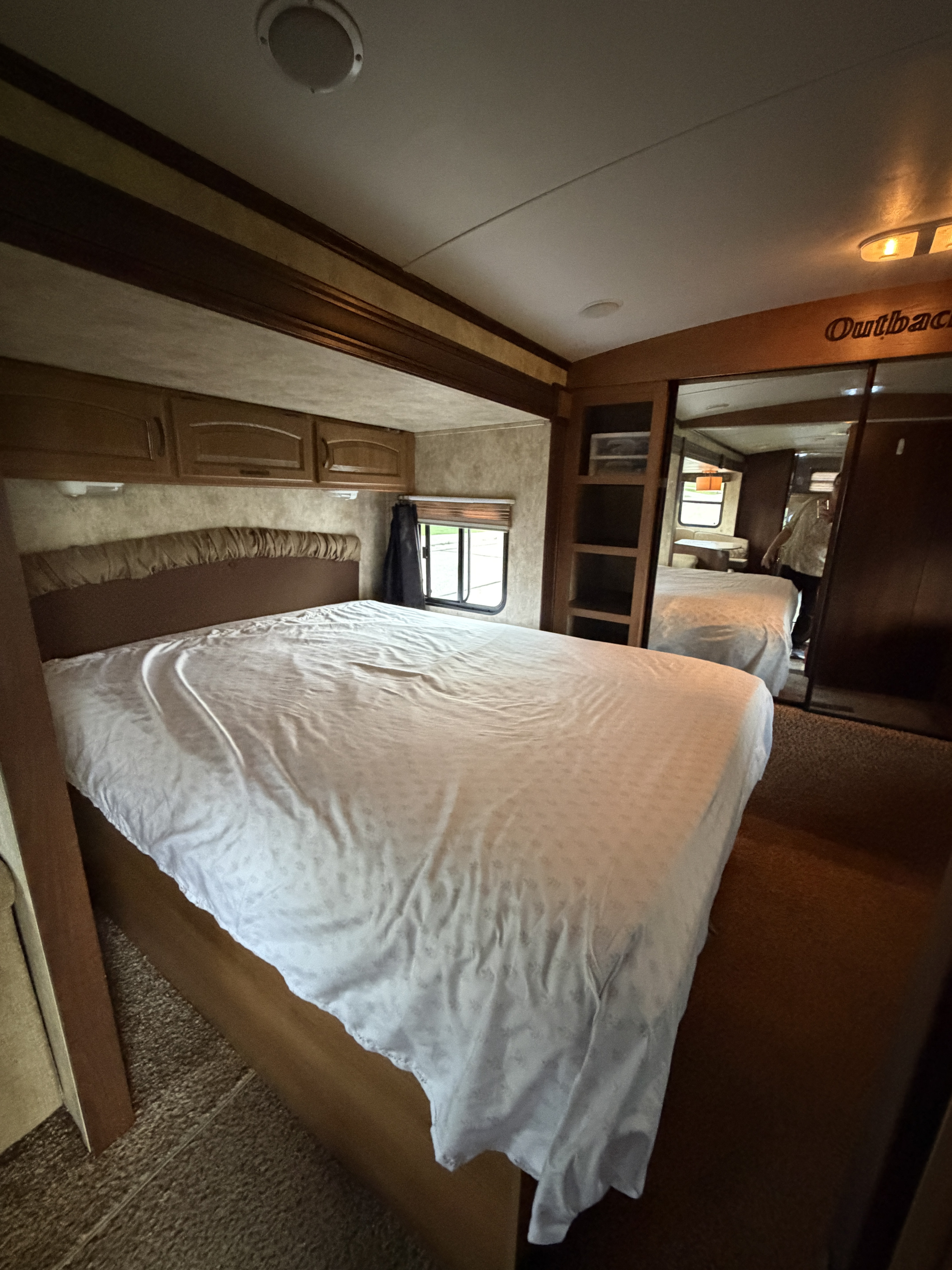 Outback RV rental bedroom: spacious bed, overhead storage, window, mirrored closet. Ready for adventures.. Keystone Outback 2012