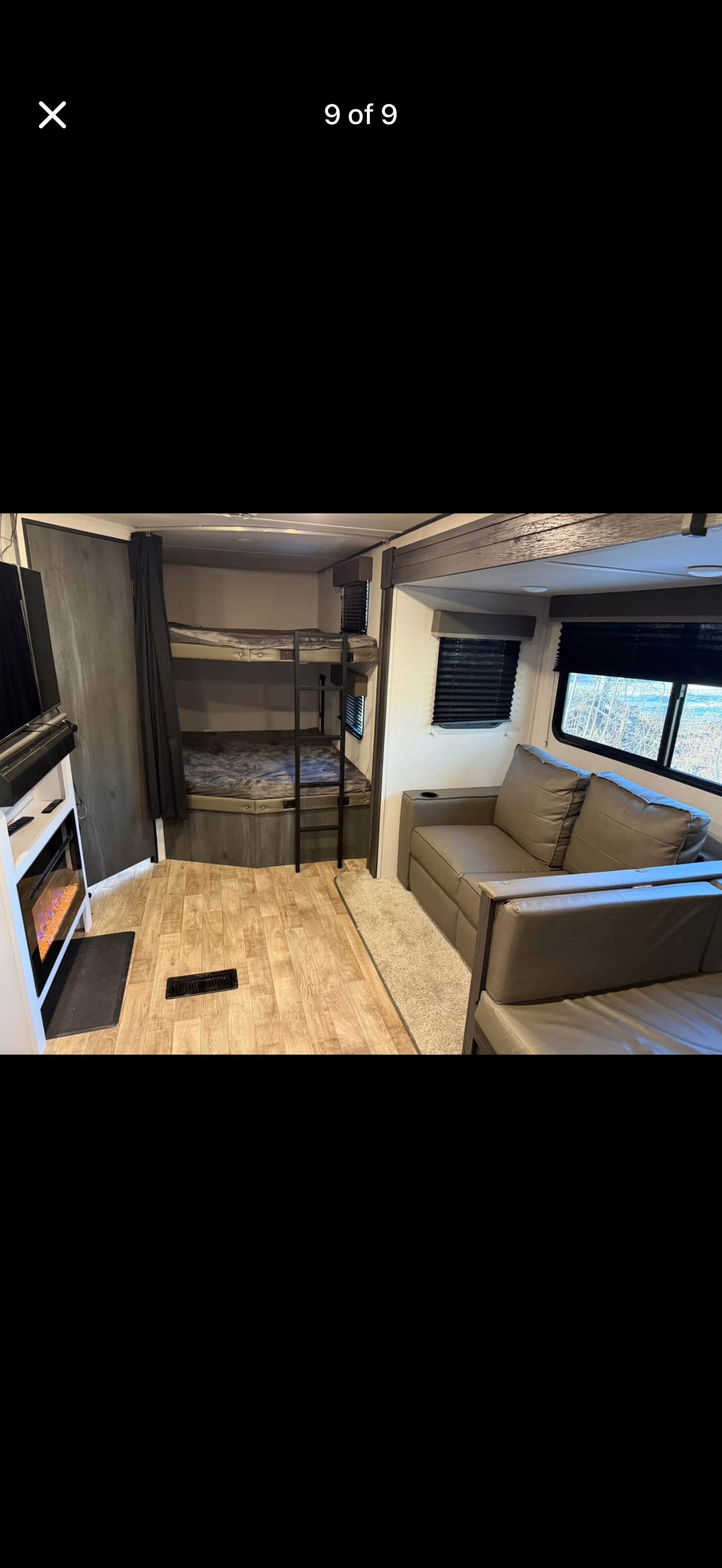 This rv rental showcases a comfortable interior with bunk beds, a sofa, and an electric fireplace.. Keystone RV Hideout 2022