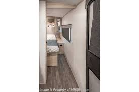 Compact RV rental bedroom interior with TV, showcasing a cozy sleeping area and modern design for comfortable travel.. Twilight RVS Signature 2022