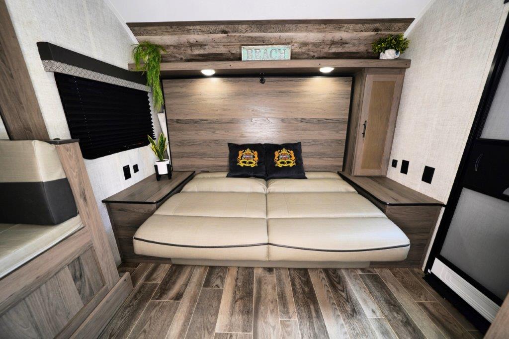 This RV rental's versatile sleeping area features a comfortable folding bed with modern wood finishes and compact design.. Gulf Stream Ameri-Lite Super Lite 2023