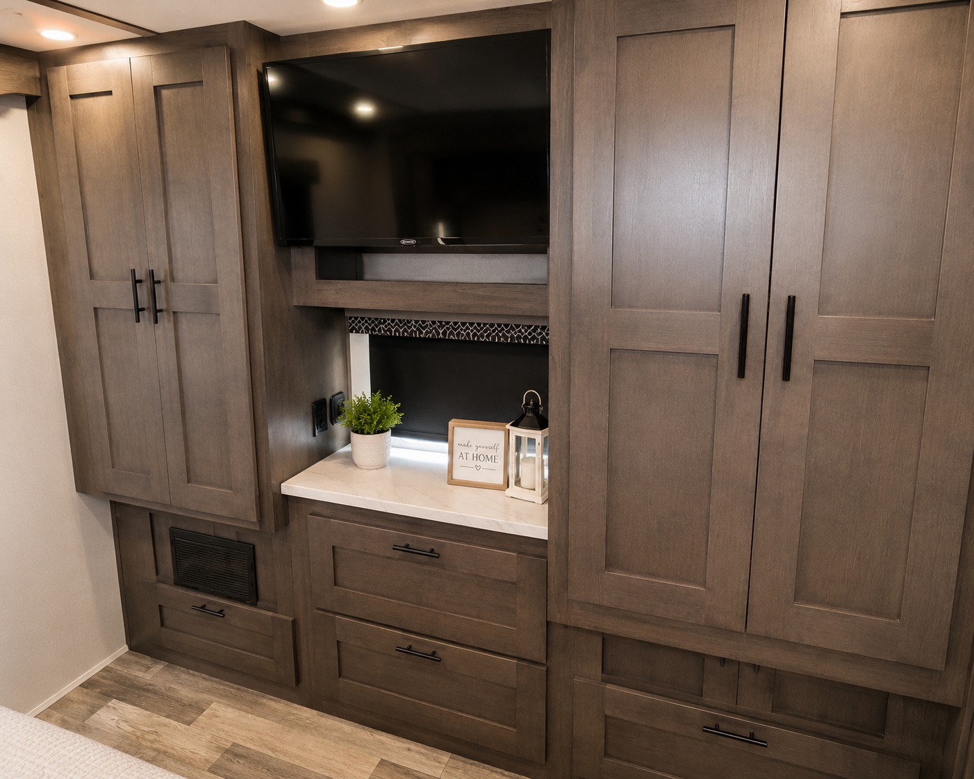 Stylish RV rental interior with wood cabinetry, entertainment TV, and homey decor elements for comfortable travel.. Forest River FR3 2022