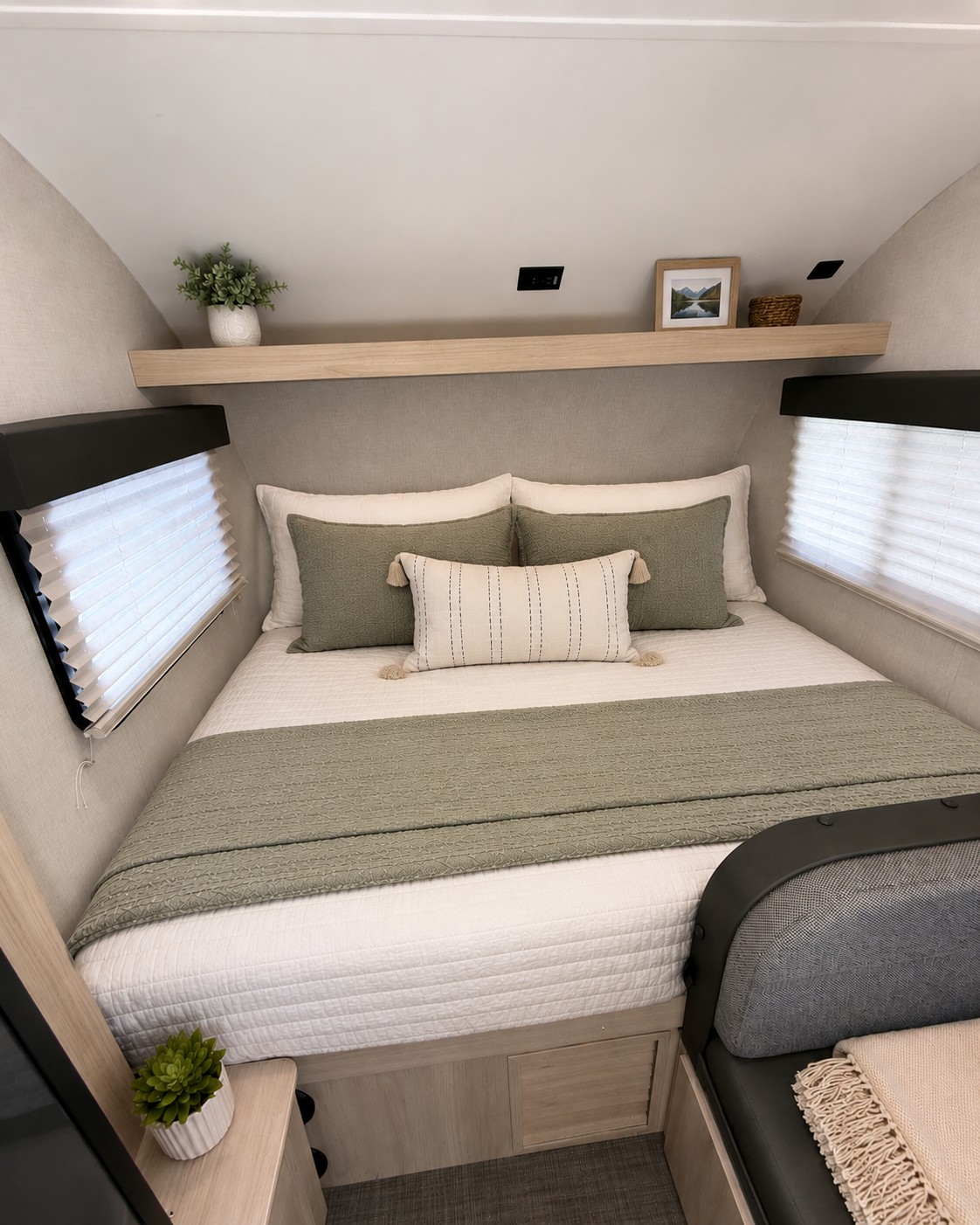 Relax in this inviting RV rental bedroom. Features a comfy bed, modern decor, and window views—ideal for your next adventure.. Winnebago Hike 2021