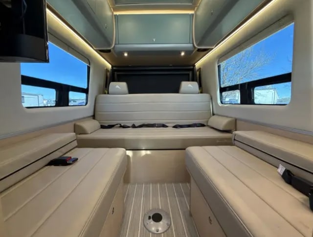 Spacious and modern RV rental interior with comfortable seating and a bed, ideal for your next road trip adventure.. Airstream Interstate 2026