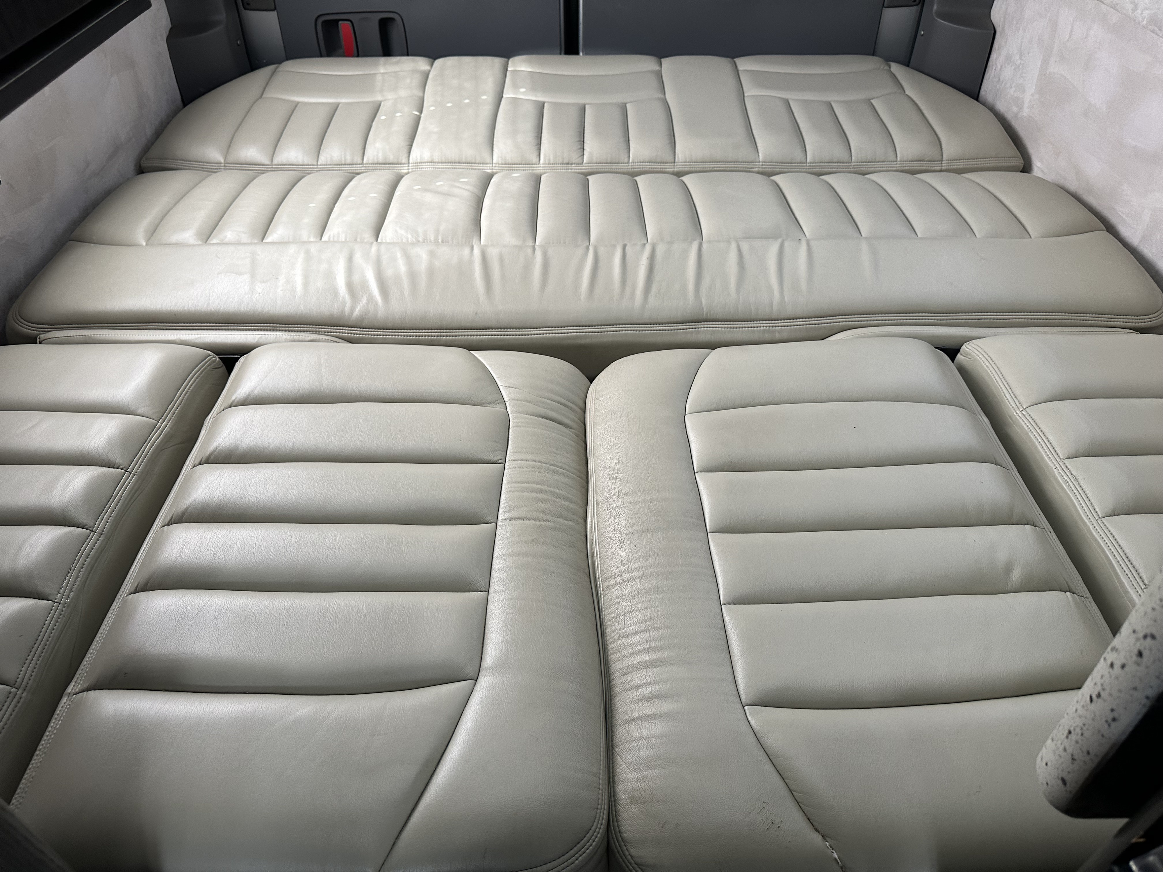 RV rental: Light cream, tufted leather/vinyl convertible seating, forming a bed in the rear and individual seats up front.. Airstream Interstate 2011