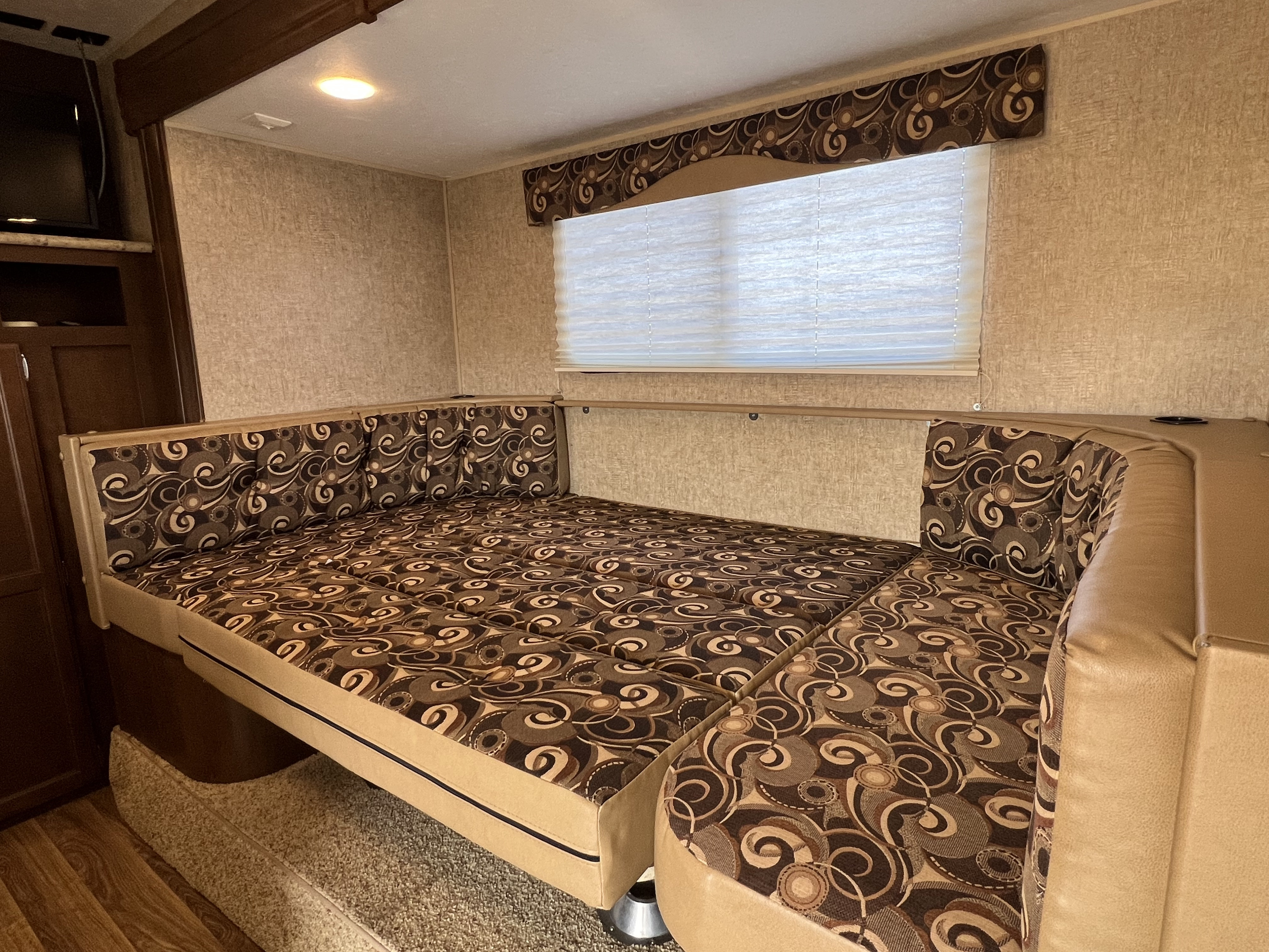 RV rental with comfy U-shaped dinette bed conversion, brown patterned cushions, and window. Perfect for travelers.. Sonic Sonic Trailer 2015