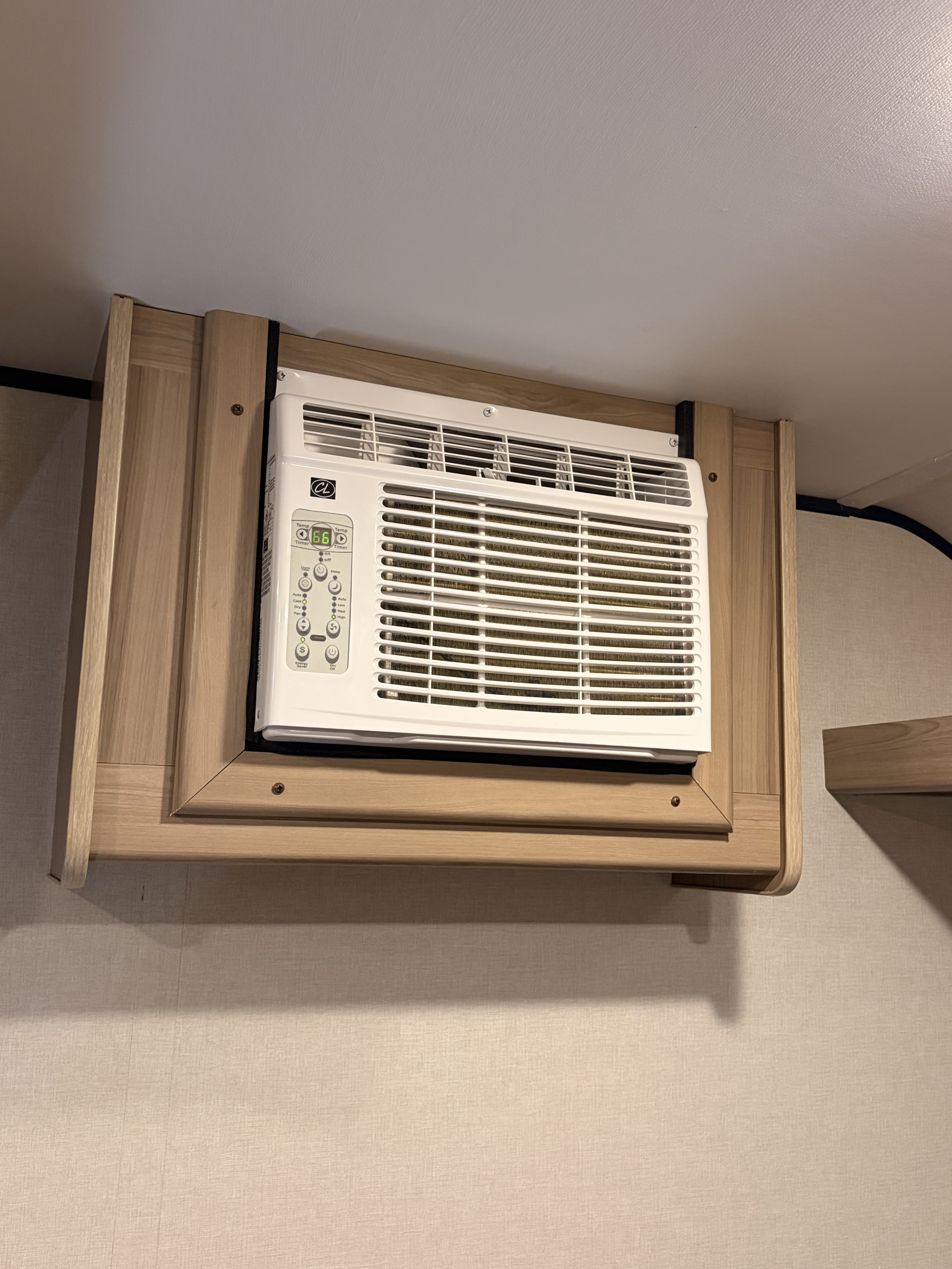 Stay cool in your RV rental with this wall-mounted air conditioning unit, displaying 66 degrees for optimal climate control and comfort.. COLEMAN 17B 2025