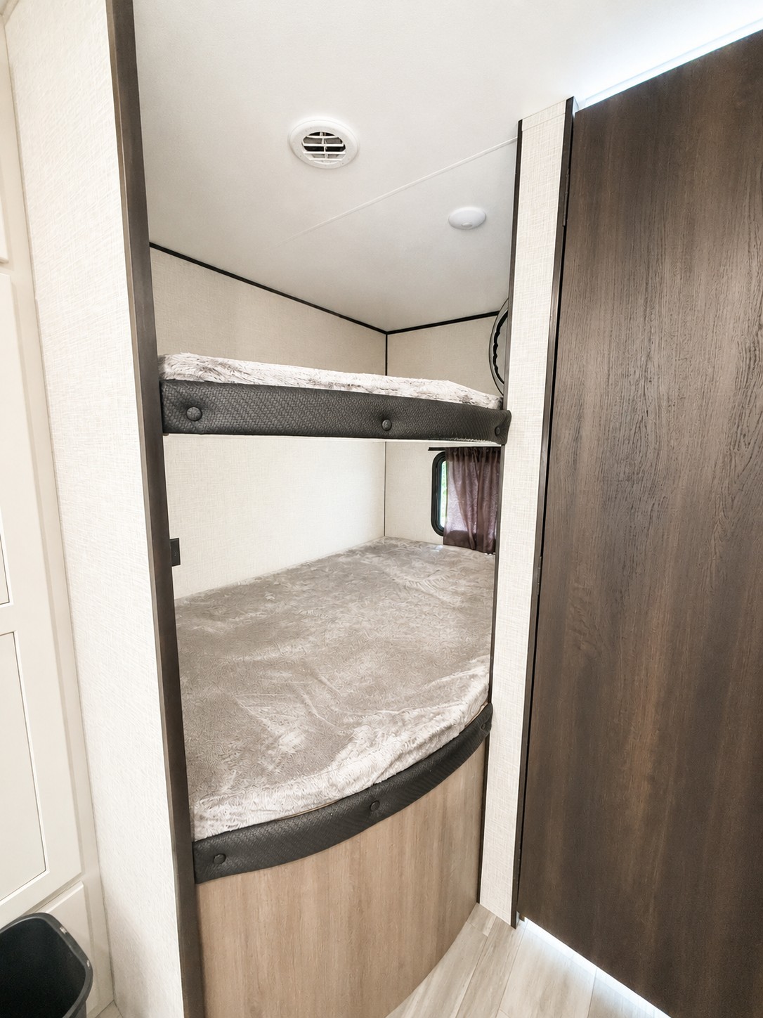 This RV rental features two cozy bunk beds, a comfortable sleeping area in a modern travel trailer, ready for your next adventure.. Jayco Jay Flight SLX 2024