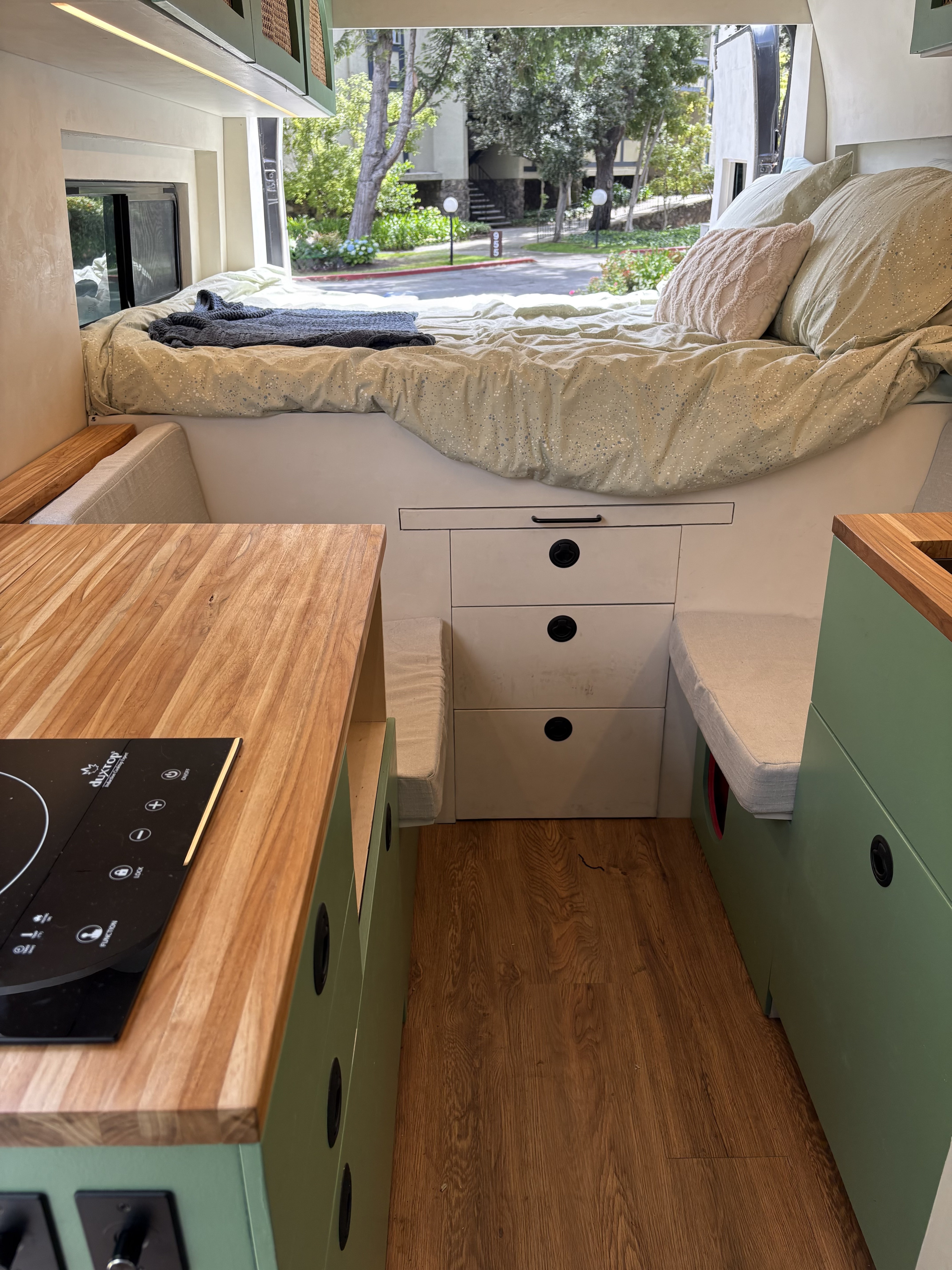 Step inside this RV rental: a comfy bed, functional kitchen with an induction cooktop, and smart storage solutions.. Ram Promaster 2500 2017