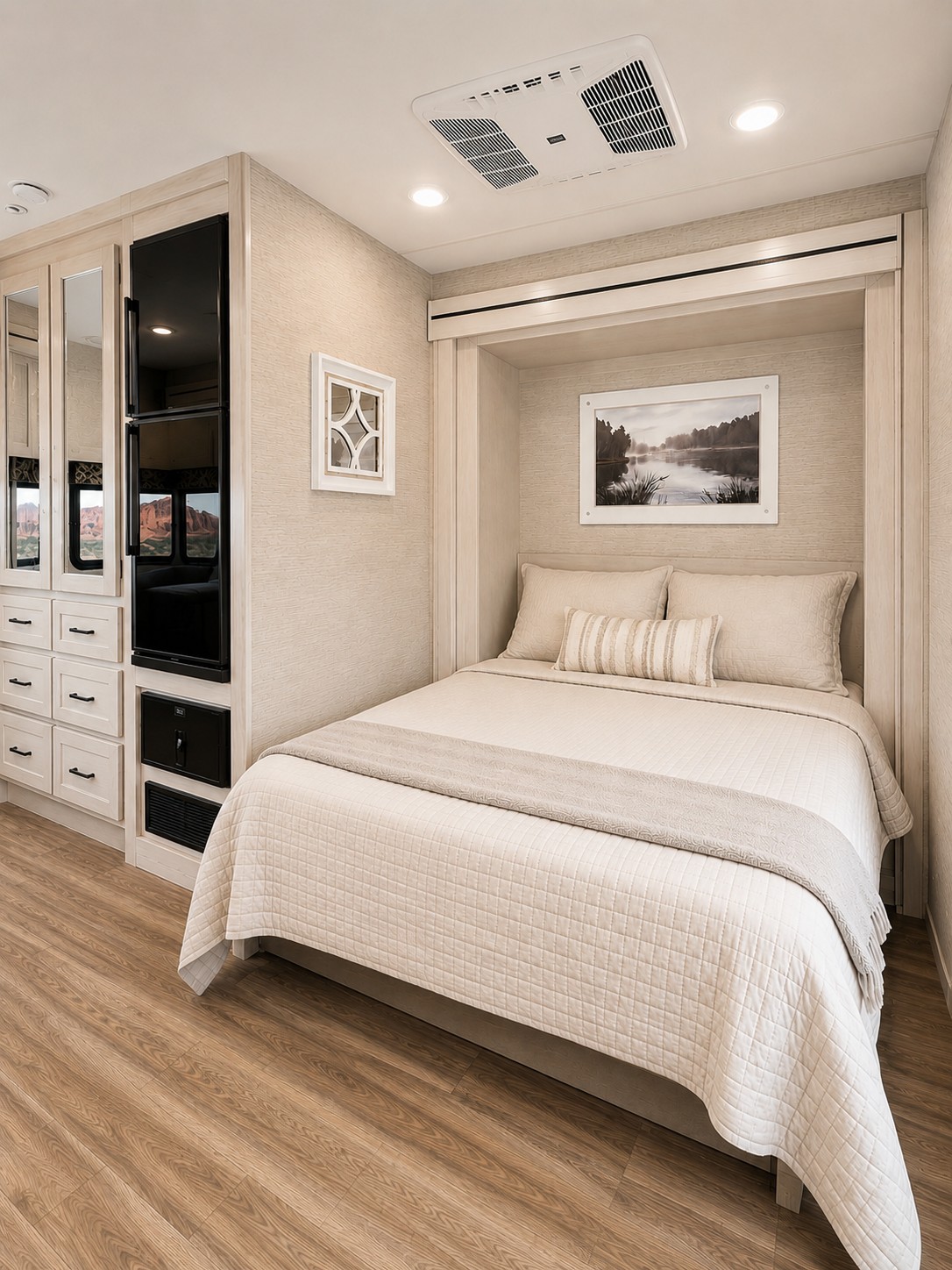 Cozy RV rental bedroom featuring a comfy bed, integrated storage, and an AC unit for your travel comfort.. Thor Axis 2022