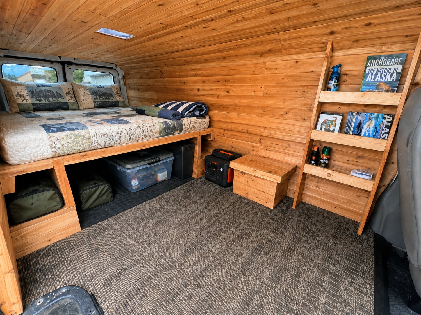 Experience comfort in this RV rental van conversion, showcasing a cozy bed, wooden interior, and smart storage solutions.. Ford Econolline 250s 1998