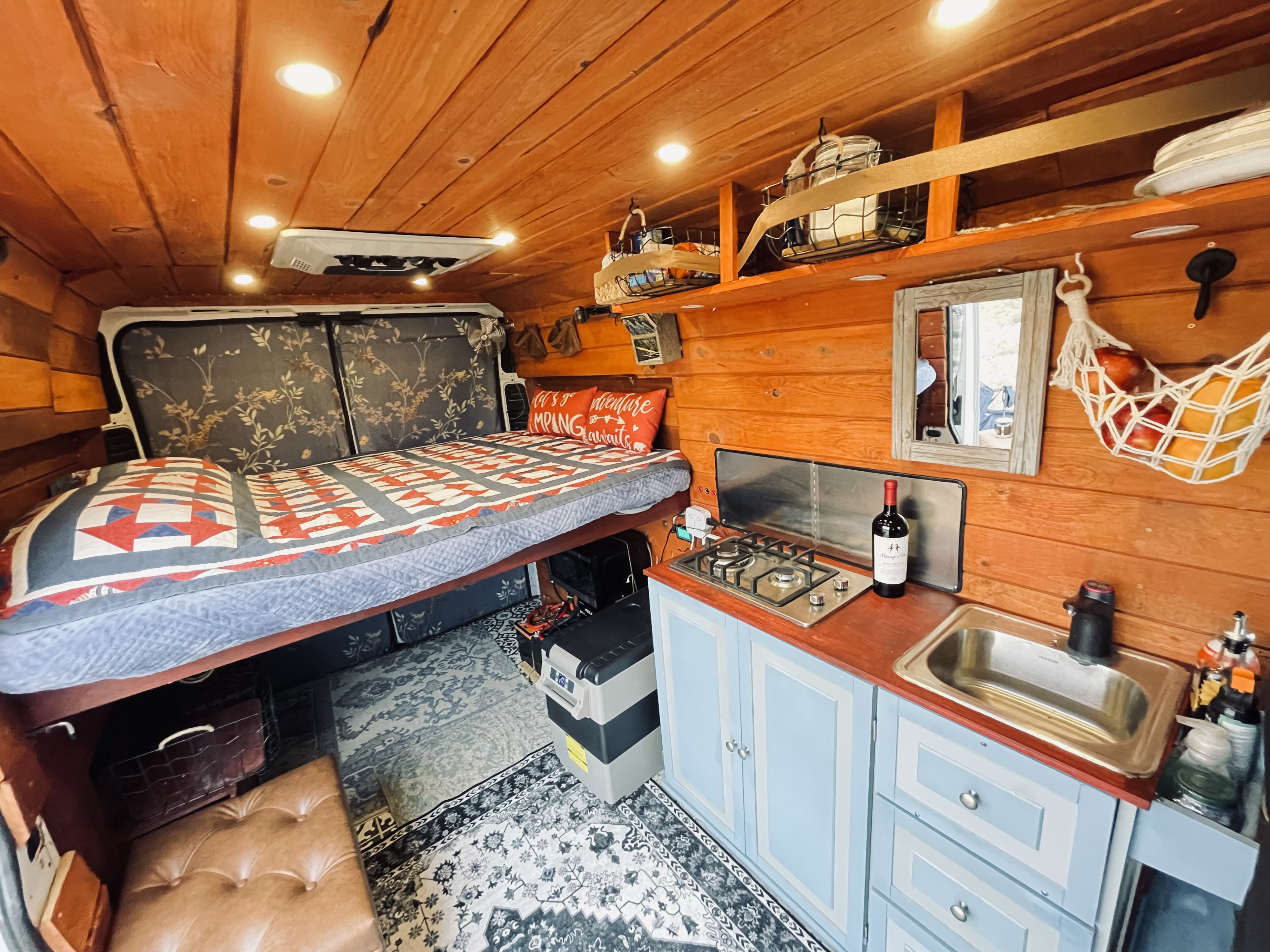 Cozy rv rental interior with a built-in bed, full kitchen, and ample storage, perfect for your next adventure.. Dodge Other 2021