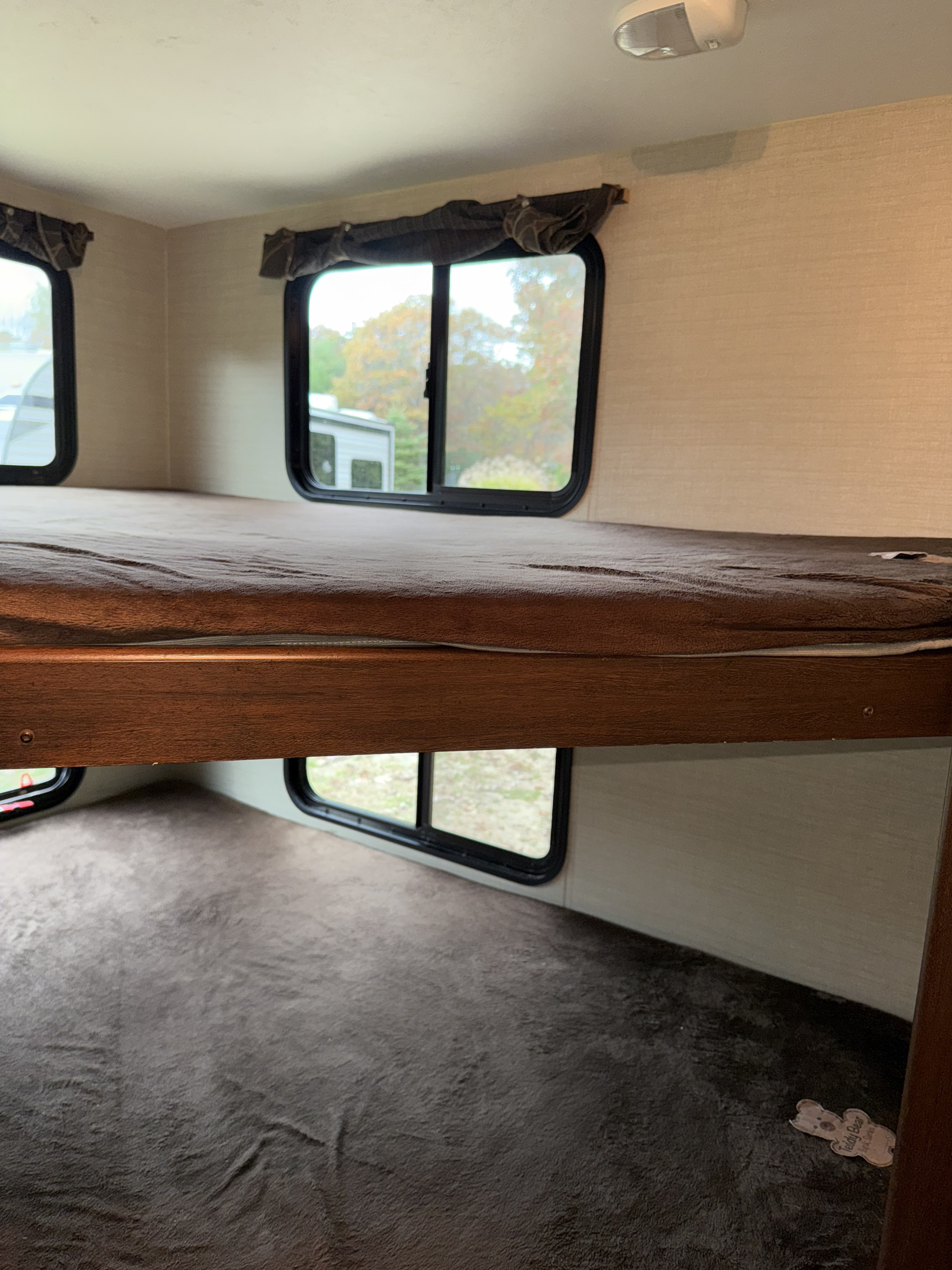 This rv rental features cozy bunk beds with scenic window views, providing comfortable accommodations for your next adventure.. Keystone RV Bullet Ultra Lite 2016
