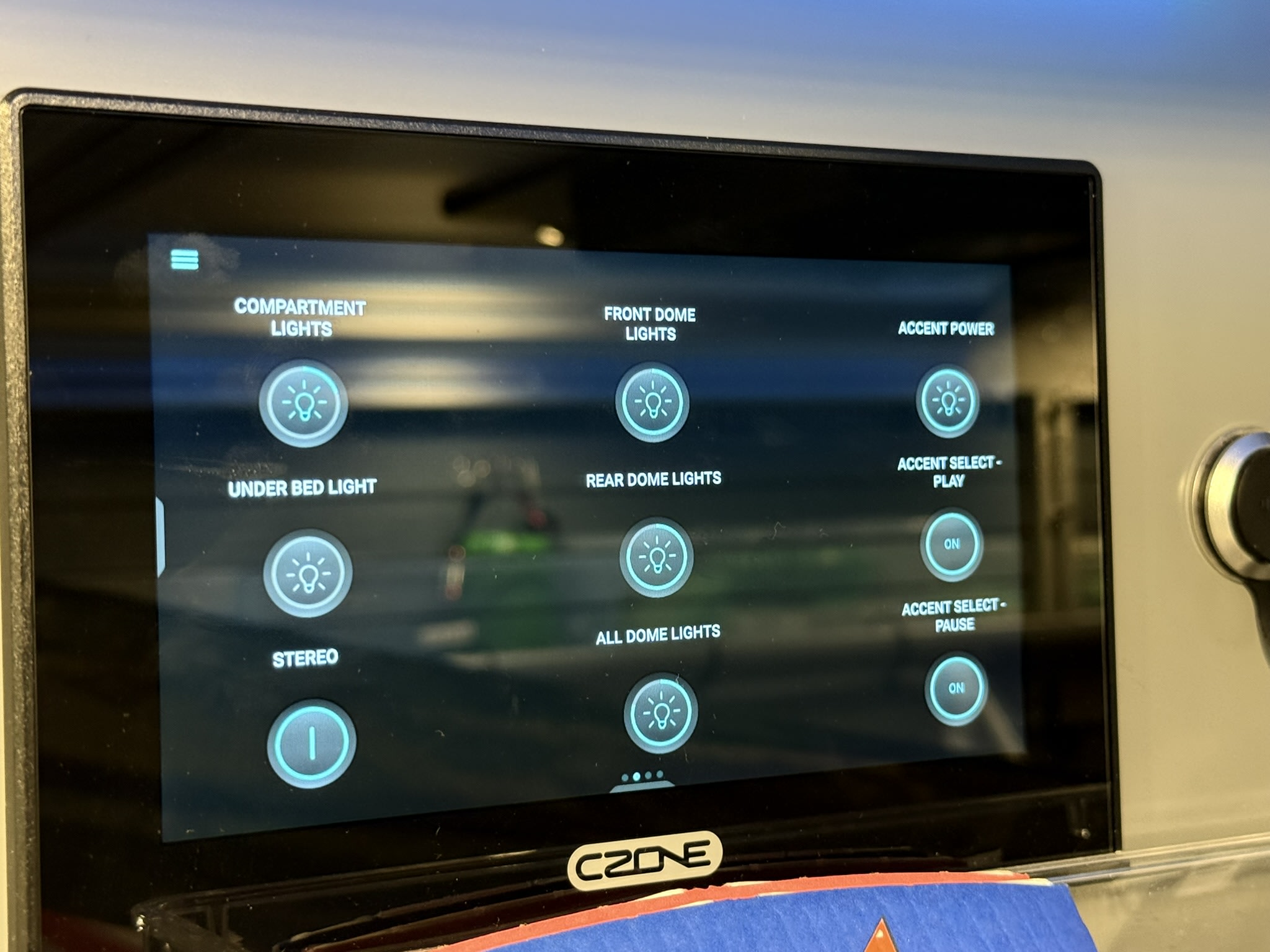 Digital CZONE panel in an rv rental, controlling compartment, dome, and under bed lights, stereo, and accent functions.. Ford Transit 2020