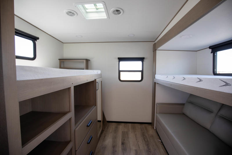 RV rental bunkhouse: two bunk beds, under-bunk storage, and a sofa for comfort & family travel.. Grand Design Reflection 100 2026