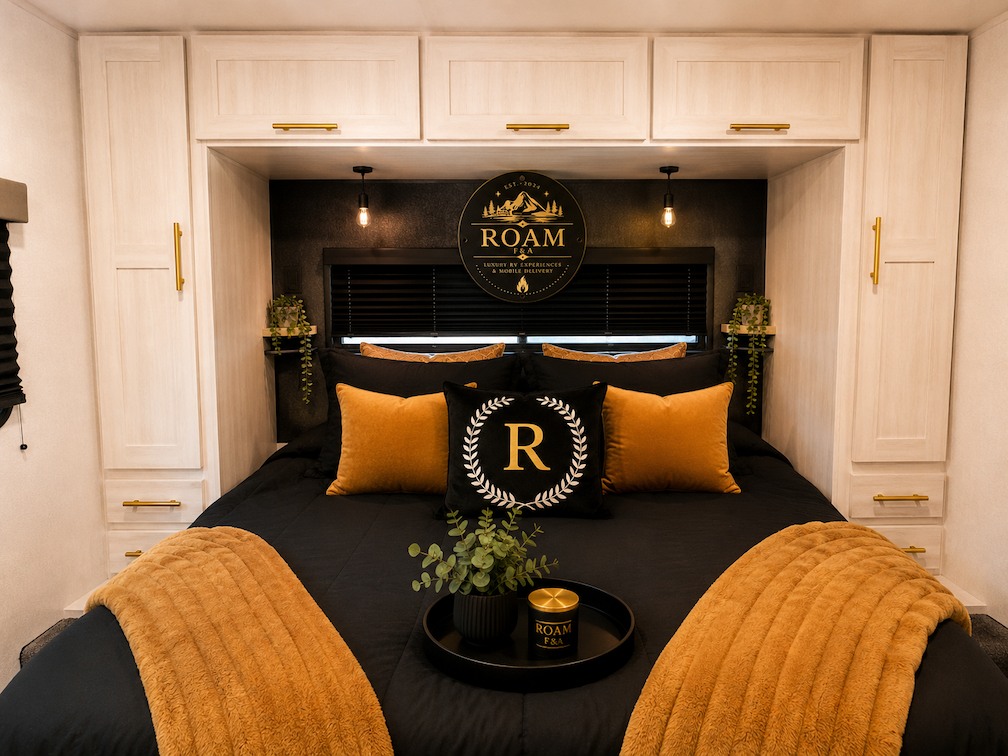 Luxurious RV rental bedroom: black bedding, gold accents, and chic cabinets. Modern comfort for your travel.. Forest River Grand Surveyor 253RLS 2024