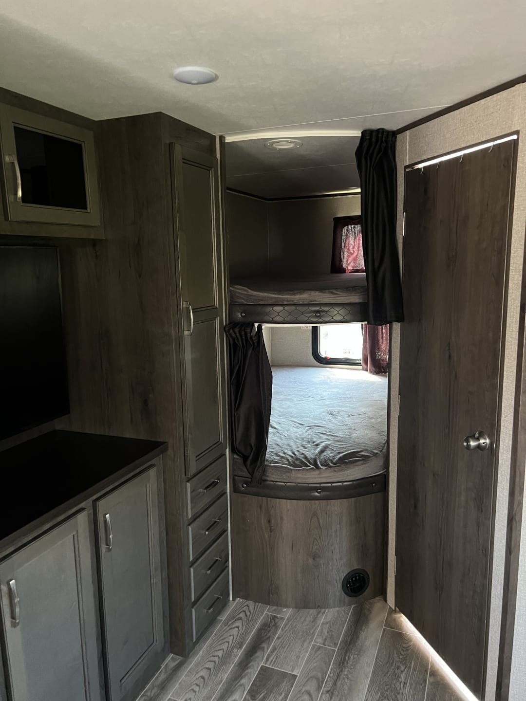 Explore this RV rental's cozy bunk beds, ample storage cabinetry, and stylish interior details for your next adventure.. Jayco Jay Flight SLX 2021