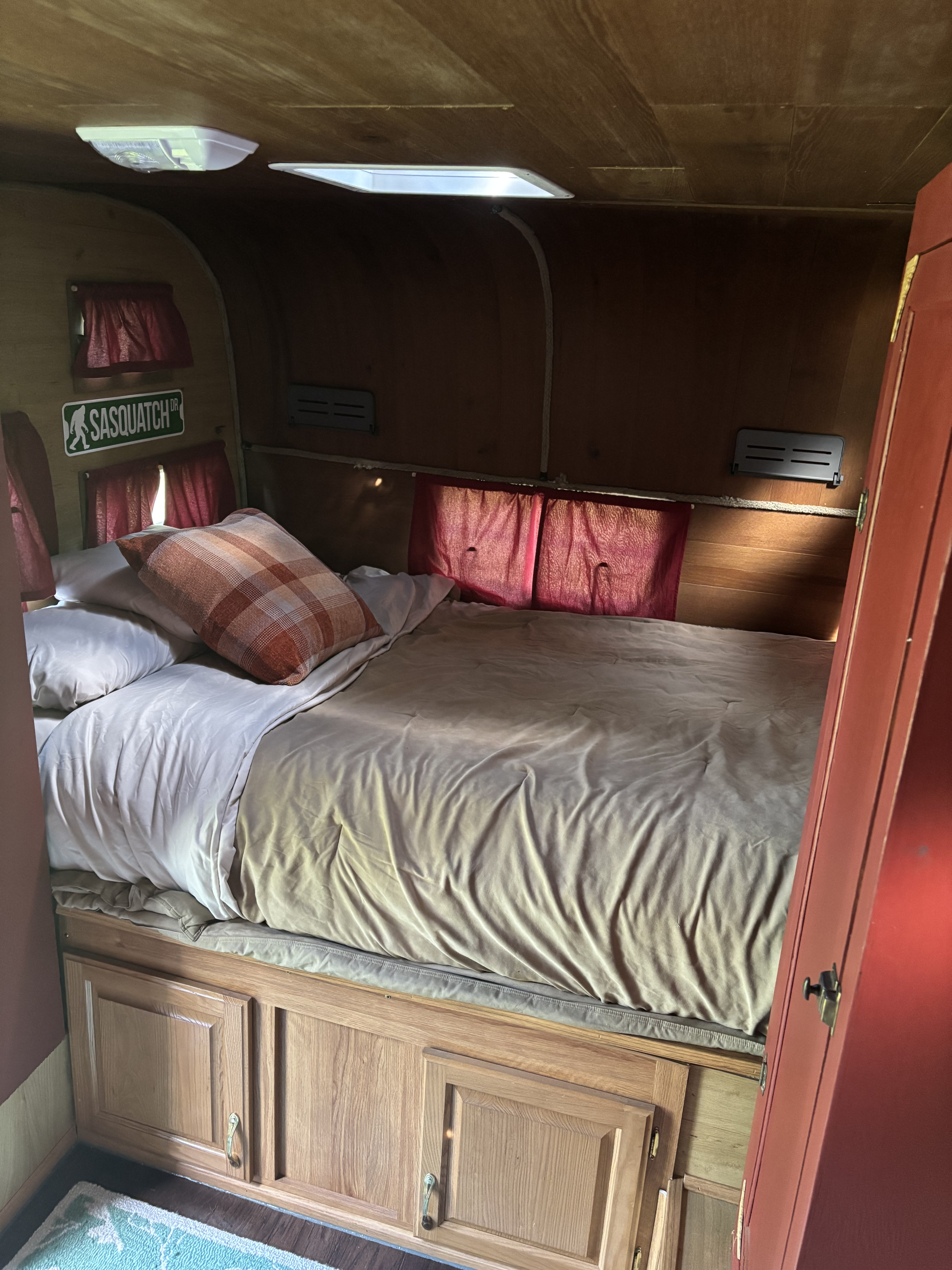 Cozy RV rental interior features a comfortable bed, wood-paneled walls, and built-in storage cabinets.. Silver Eagle 17 1966