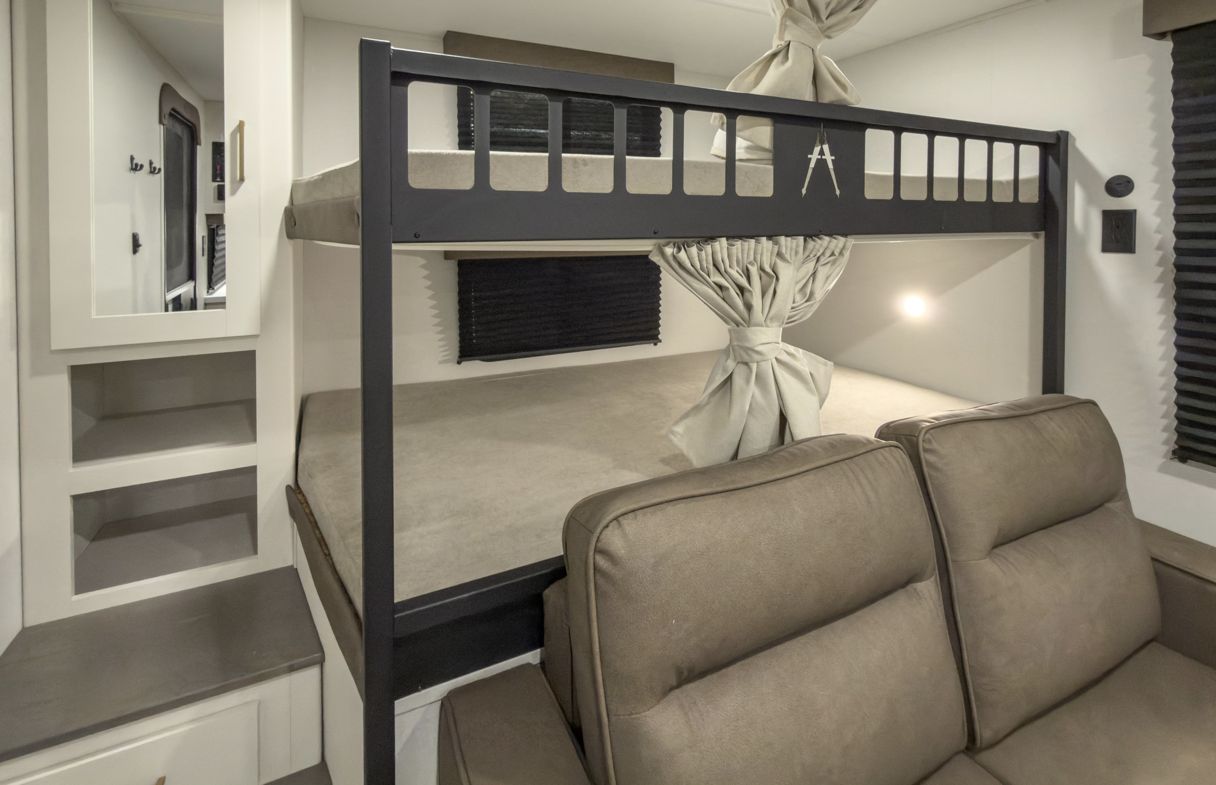 Cozy RV rental interior featuring functional bunk beds, plush seating, and convenient built-in storage.. Grand Design Transcend 2027
