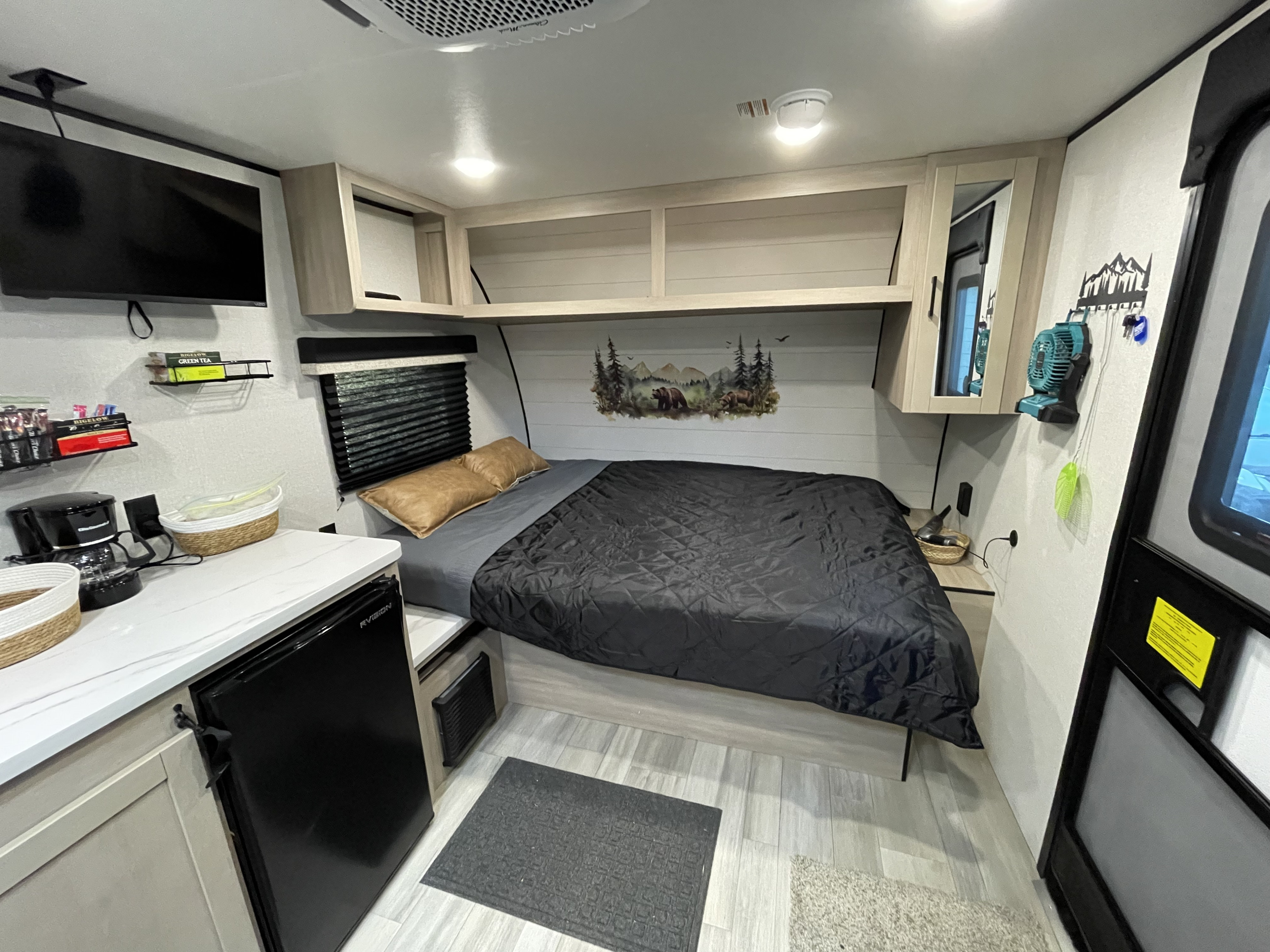 RV rental interior: A compact bedroom, small kitchenette with mini-fridge, TV, and cabinets for a cozy trip.. Jayco Heartland Prowler Lynx 2026