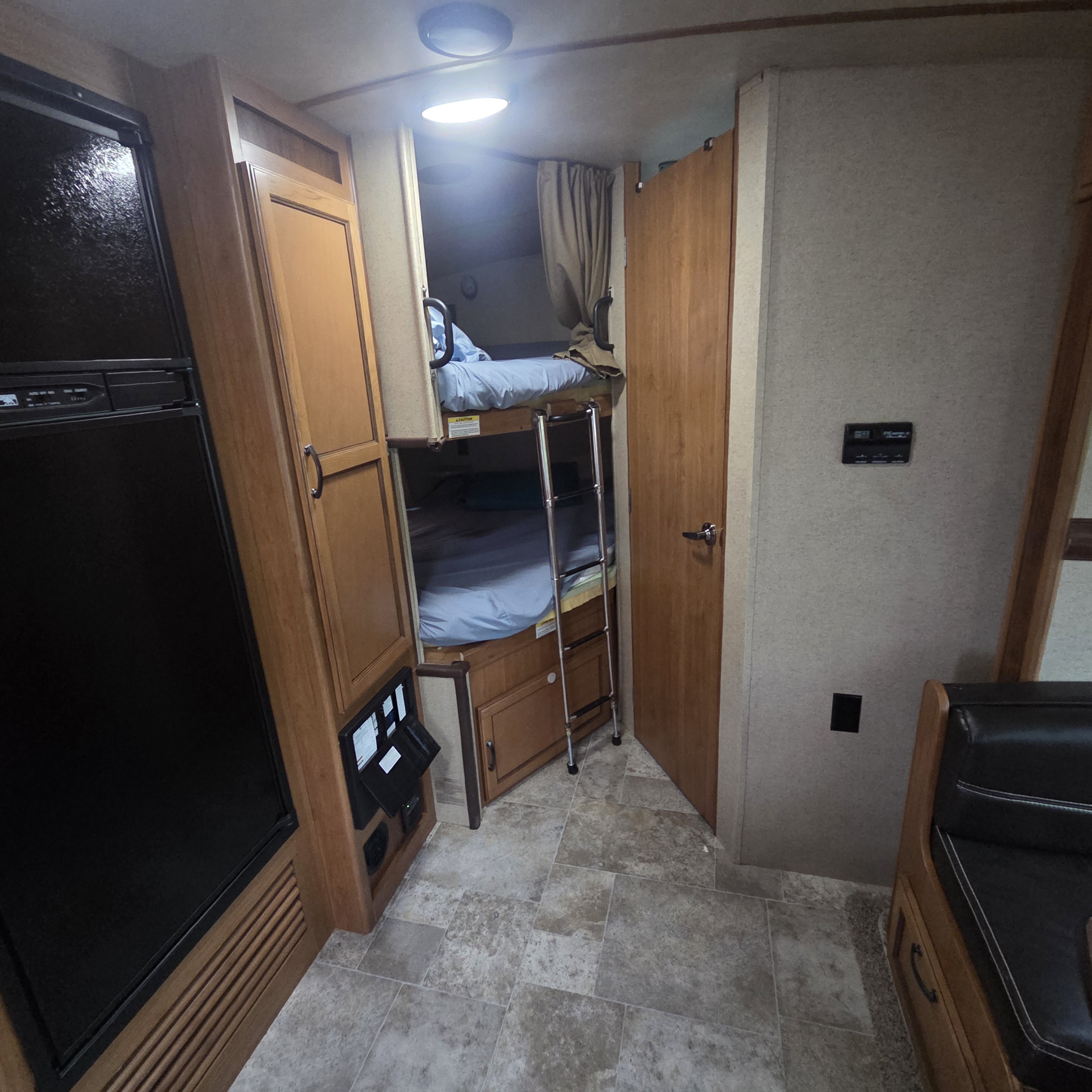 Explore this RV rental's functional interior: bunk beds with ladder, refrigerator, and dinette offer comfortable travel for families.. Crossroads RV Sunset Trail Super Lite 2016