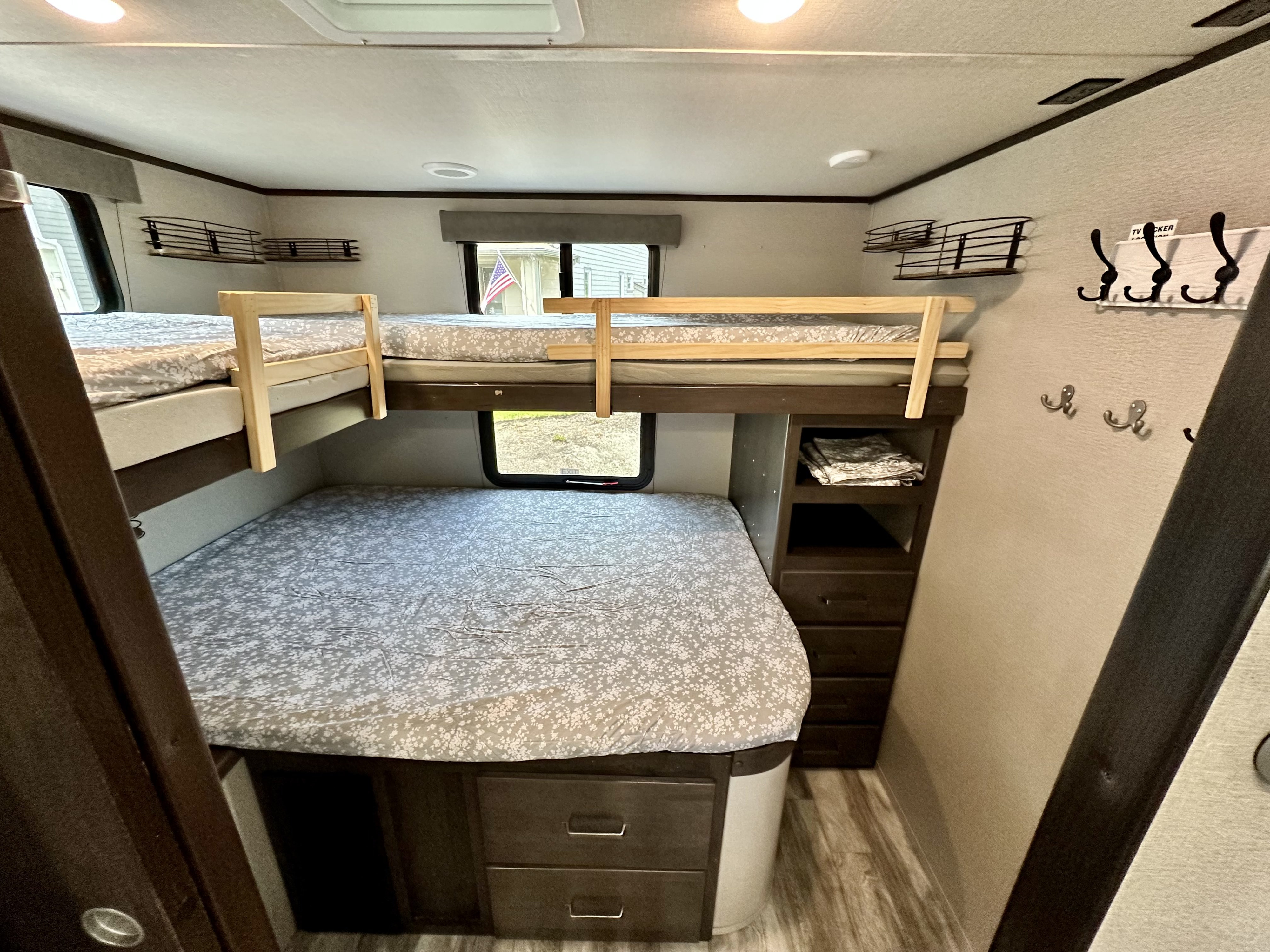 Cozy bunk beds and efficient storage inside this RV rental, providing comfortable sleeping and living space for travelers.. Grand Design Transcend Xplor 2022