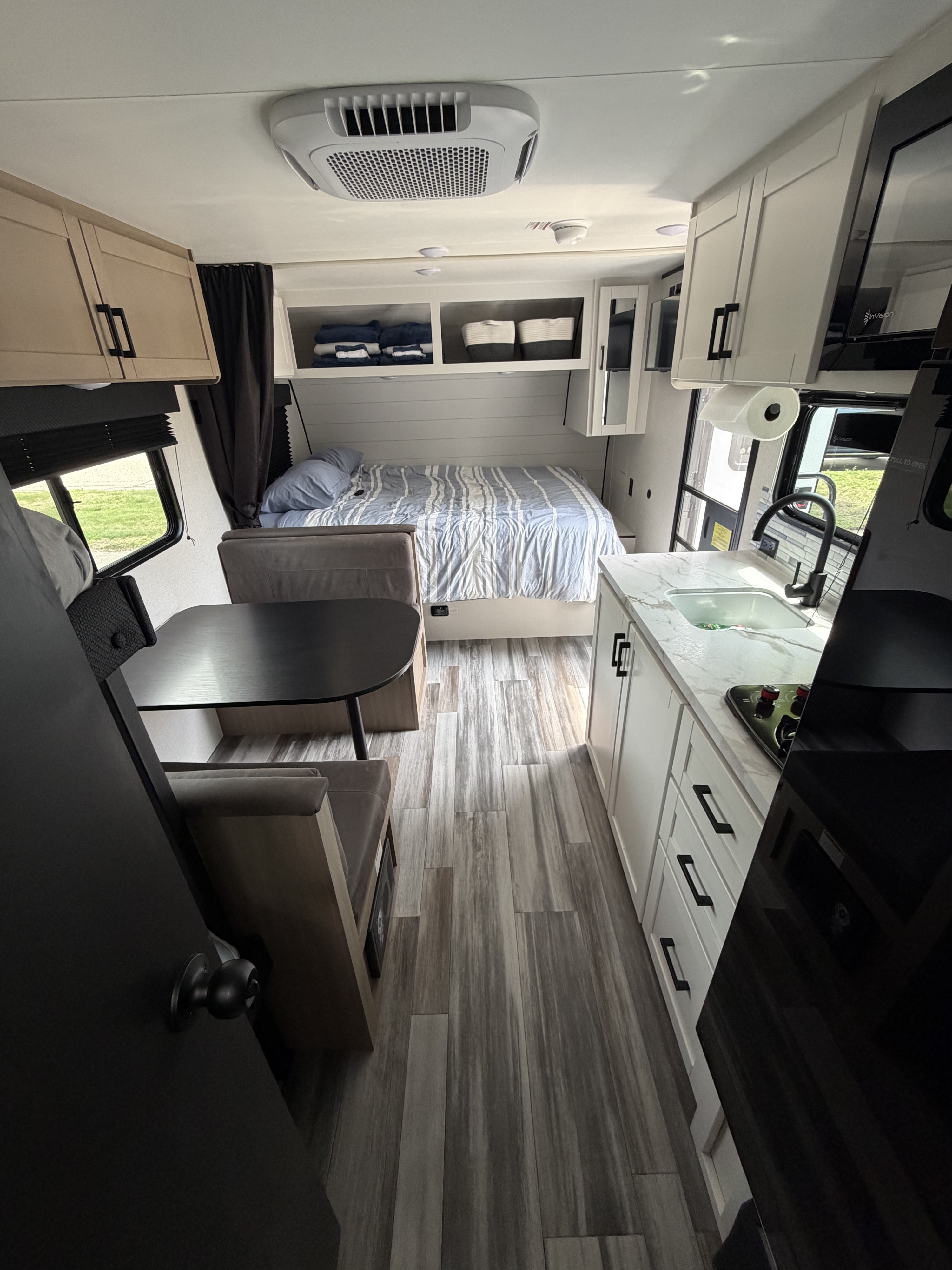 Modern RV rental interior: cozy bed, full kitchen, and dinette. Your next travel adventure starts here!. Jayco Jay Flight SLX 2026