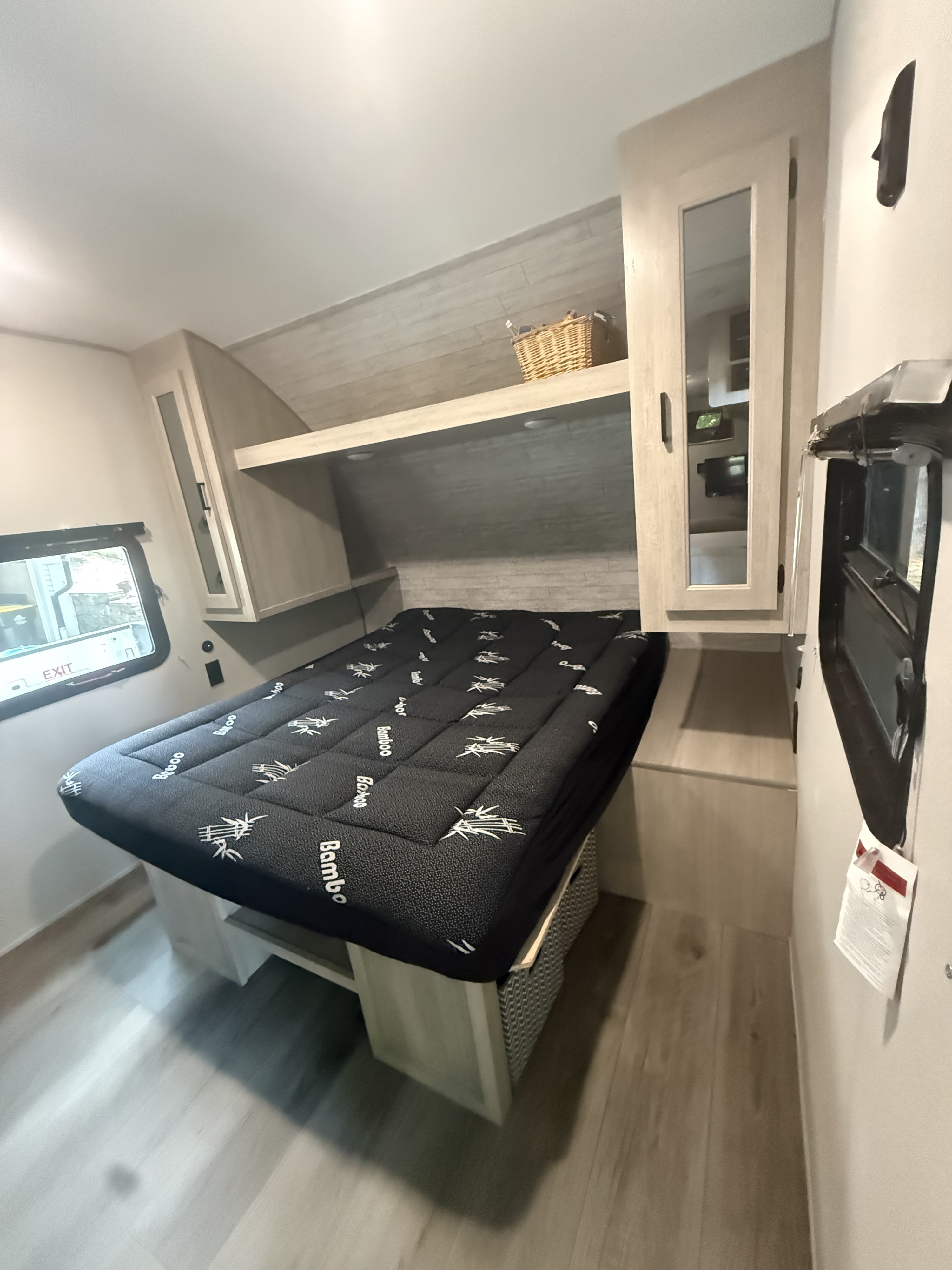 RV rental bedroom interior: modern bed with 'Bamboo' topper, light wood cabinets, and window. A clean, comfortable space.. Coachmen CATALINA SUMMIT 211BH 2026