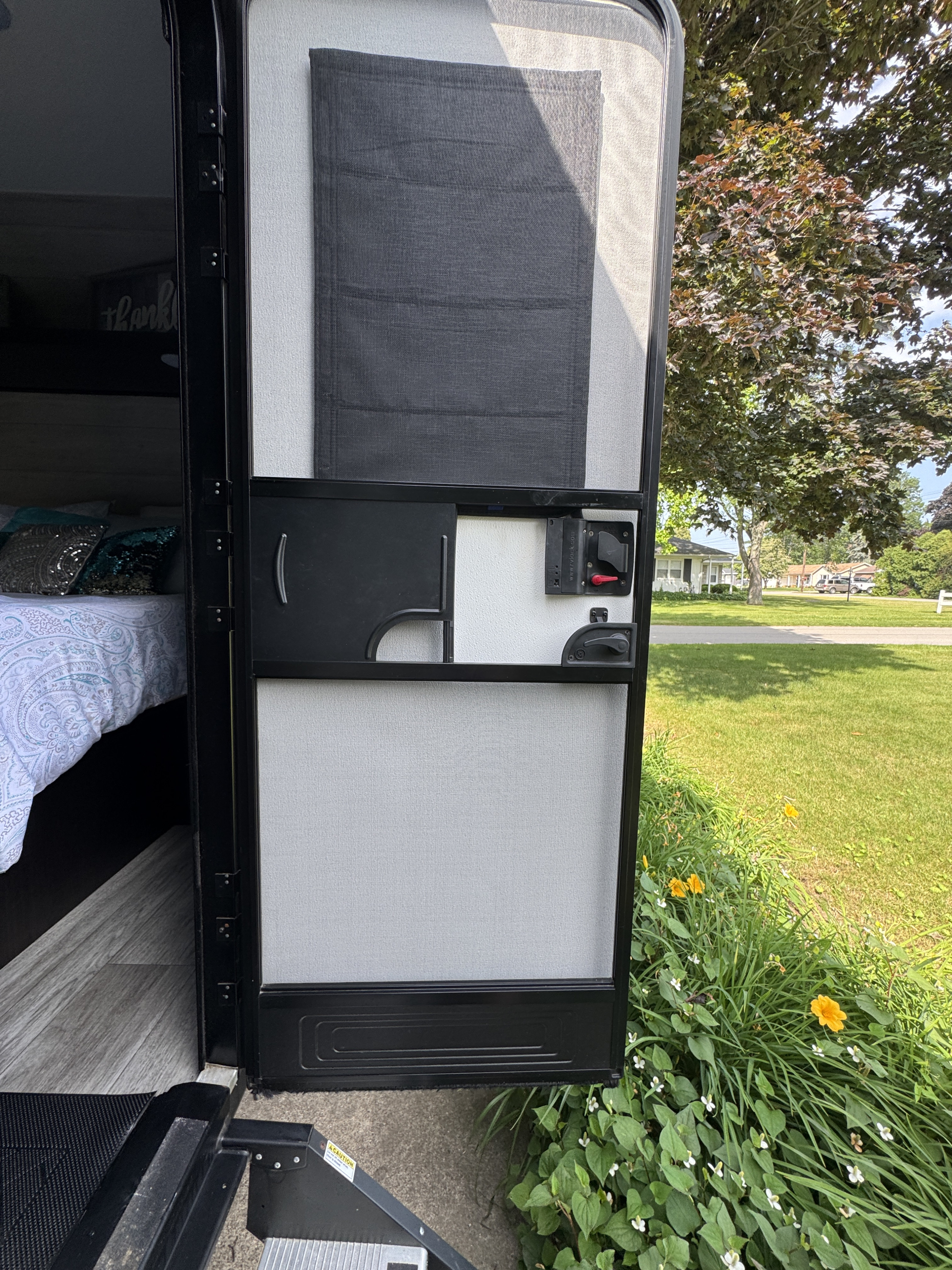 Experience an rv rental! Open screen door reveals the cozy interior bed and scenic outdoor views from the camper.. Jayco Jay Flight 2022