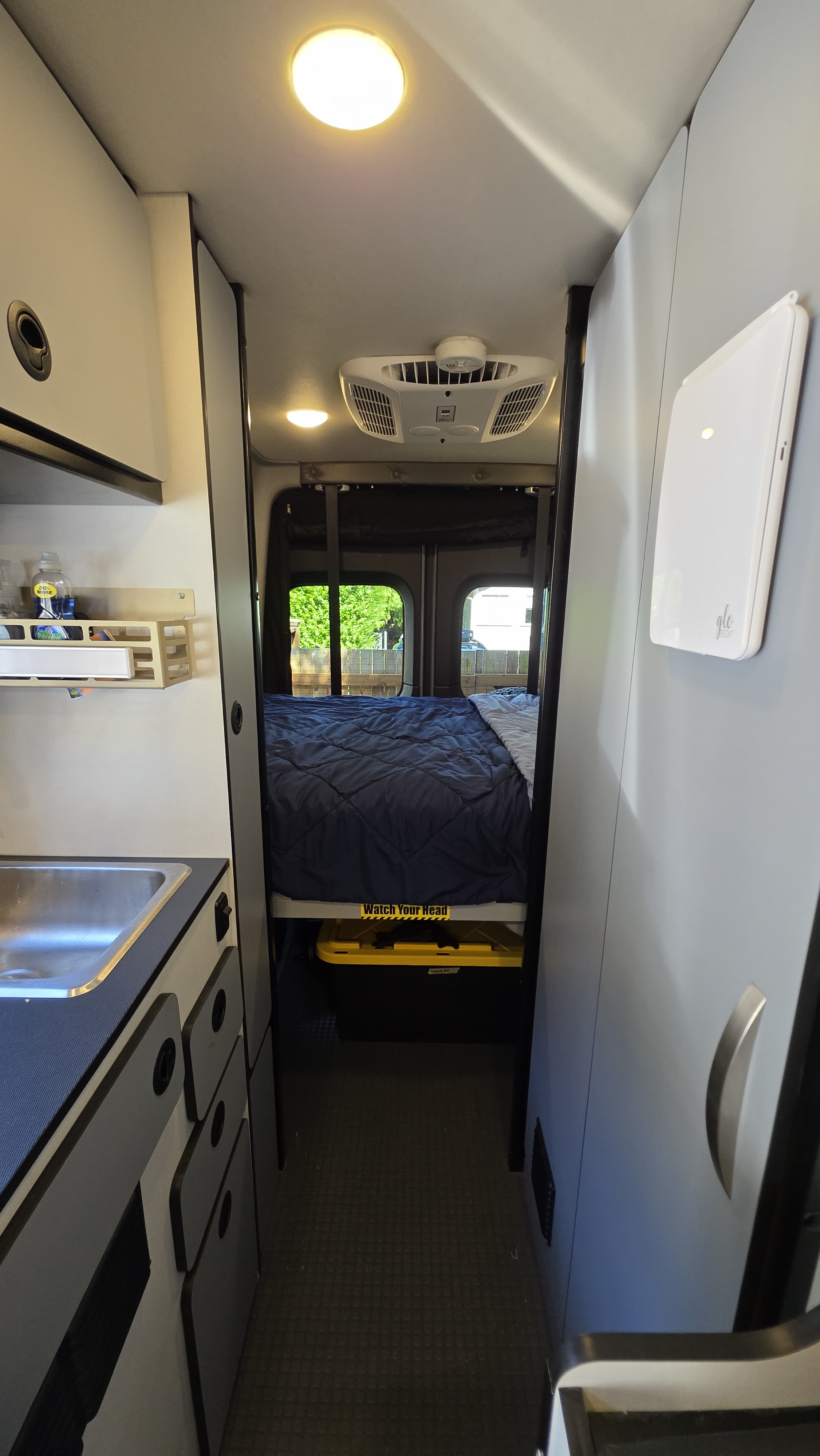 Step into this well-equipped rv rental. Features a comfortable bed, compact kitchen, overhead AC, and ample storage for your journey.. Winnebago Revel 2021