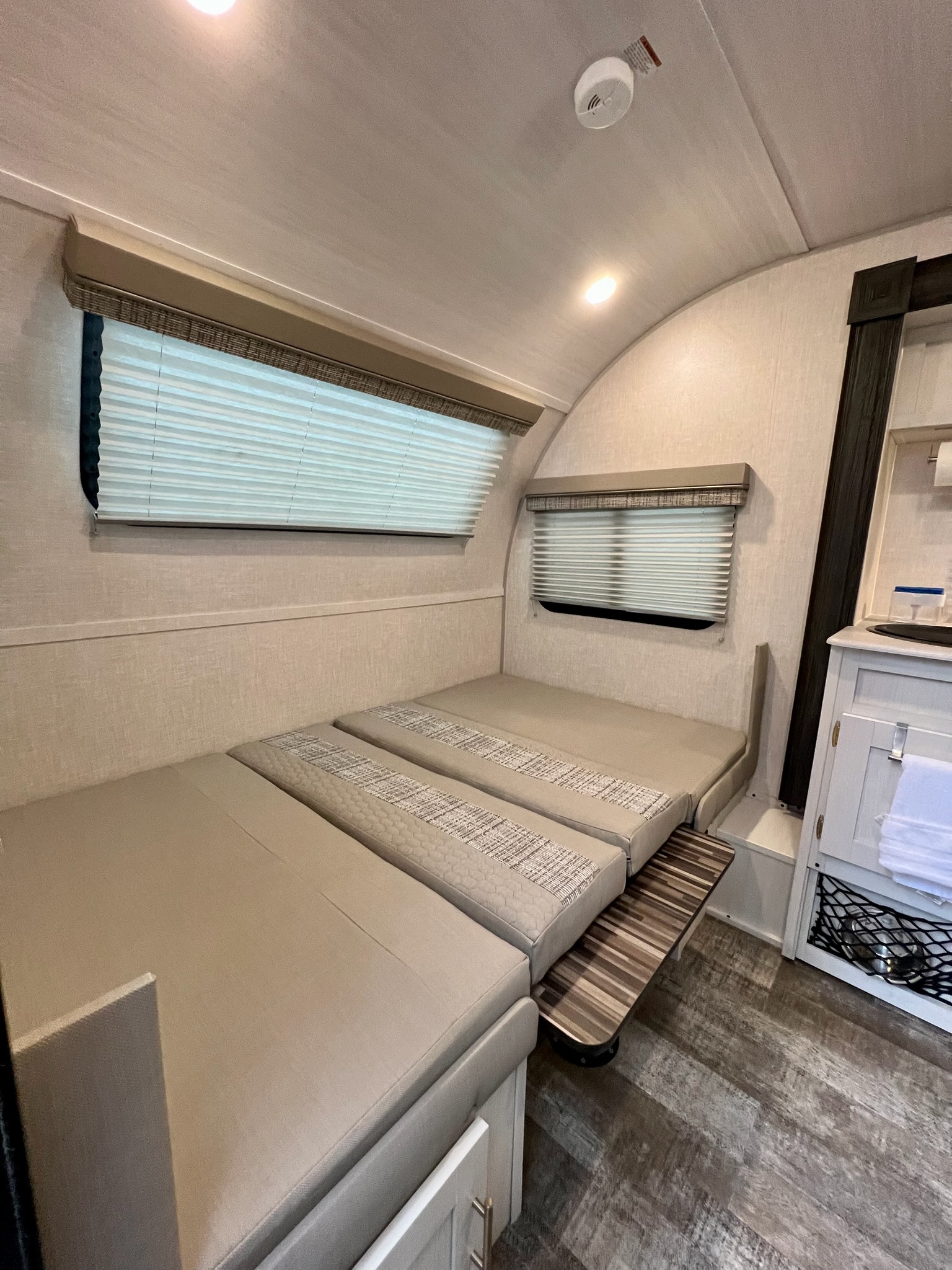 RV rental: Interior shows two cozy sofa sections, likely convertible to a bed, with windows, blinds, and a small cabinet.. Forest River R-Pod 190 2021