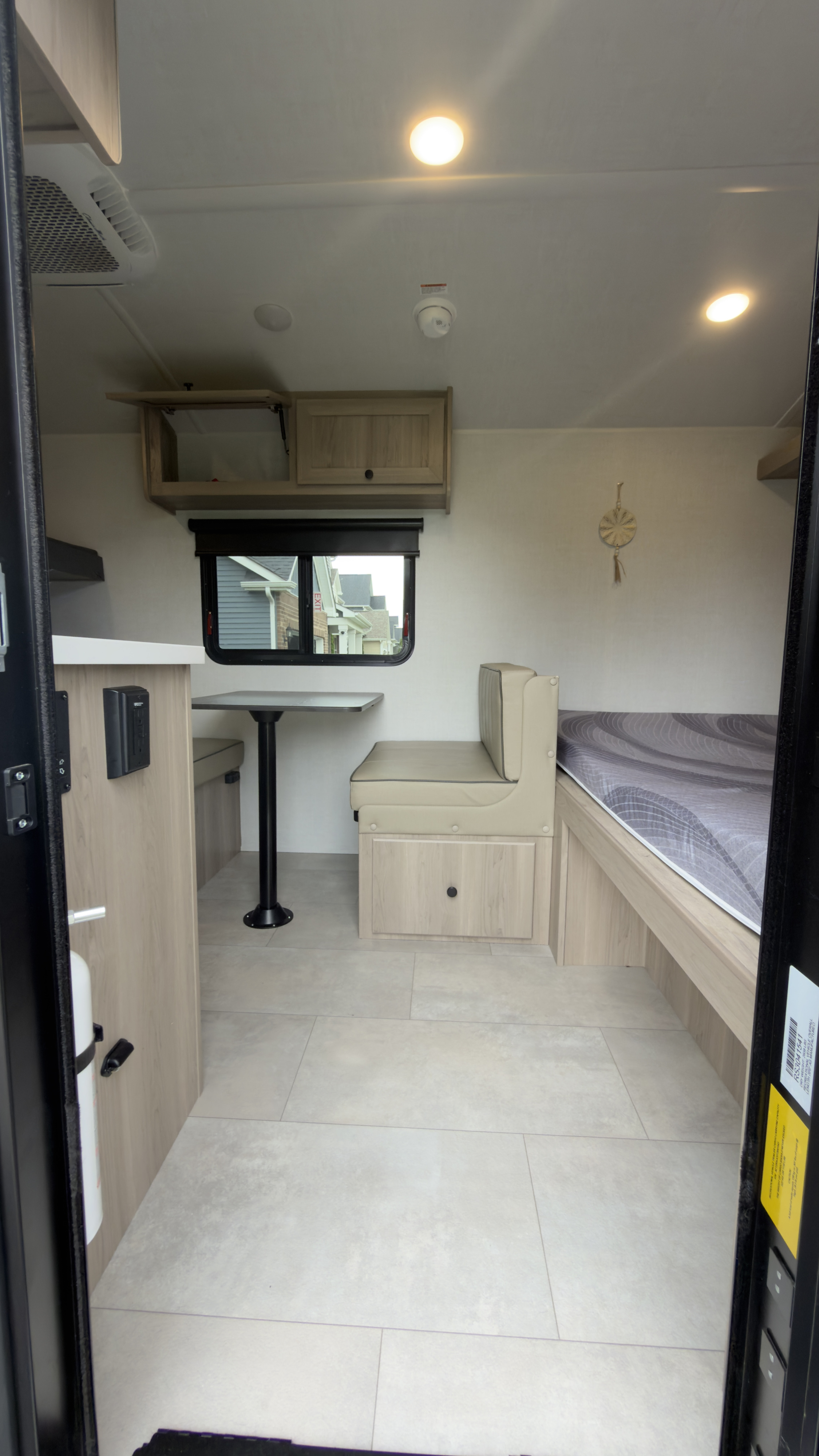 Spacious, modern RV rental interior. Features a comfy dinette, bed, overhead storage, and AC for a great trip.. Forest River Rockwood Geo Pro G17 LE 2026