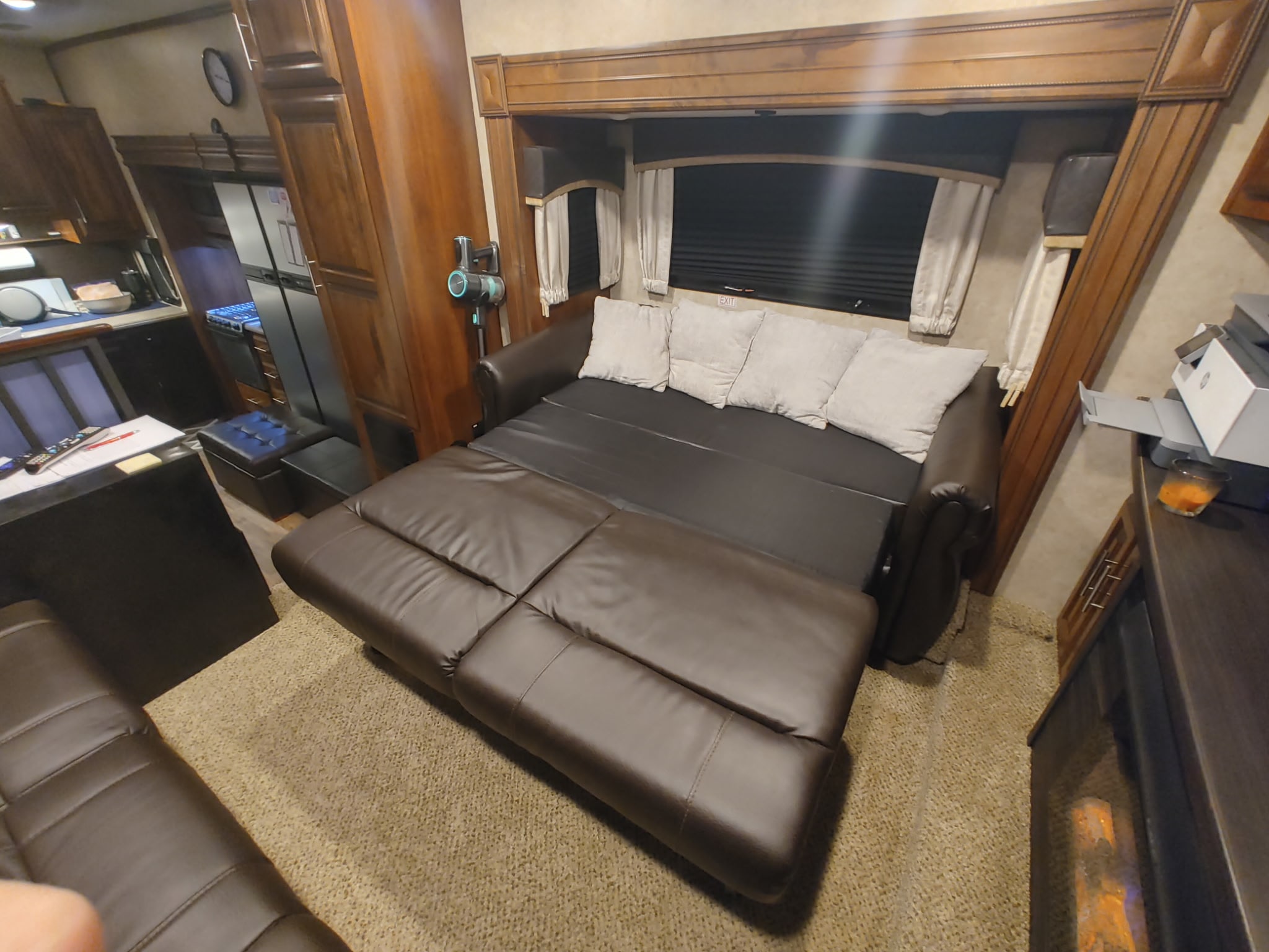 Extended dark brown pull-out sofa bed in an rv rental, showcasing the cozy living space and extra sleeping.. Jayco Eagle 2018
