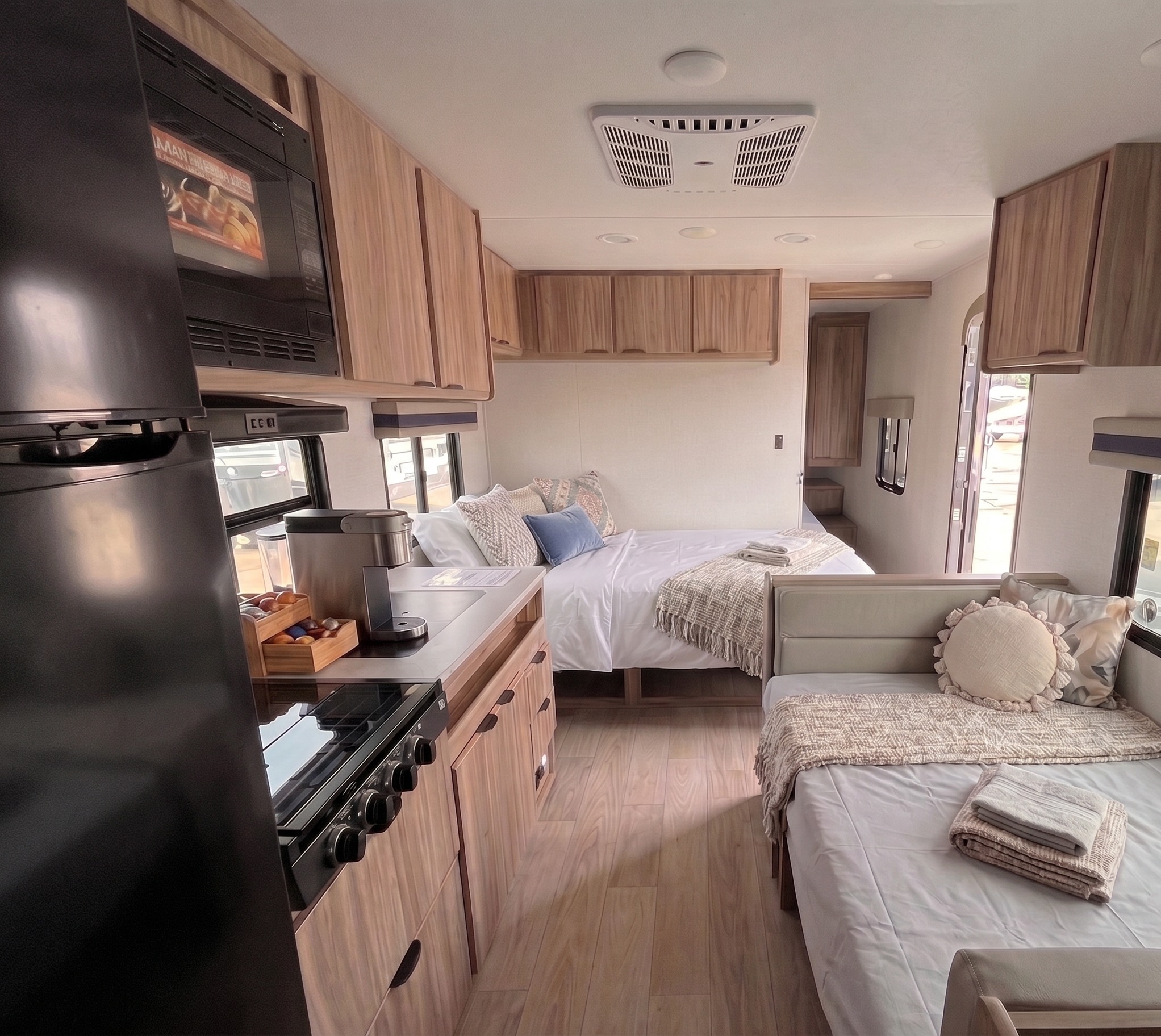 Step inside this modern **RV rental**: a compact kitchen with appliances, a comfy main bed, and an additional sleeping nook await your adventure.. Winnebago Access 2025