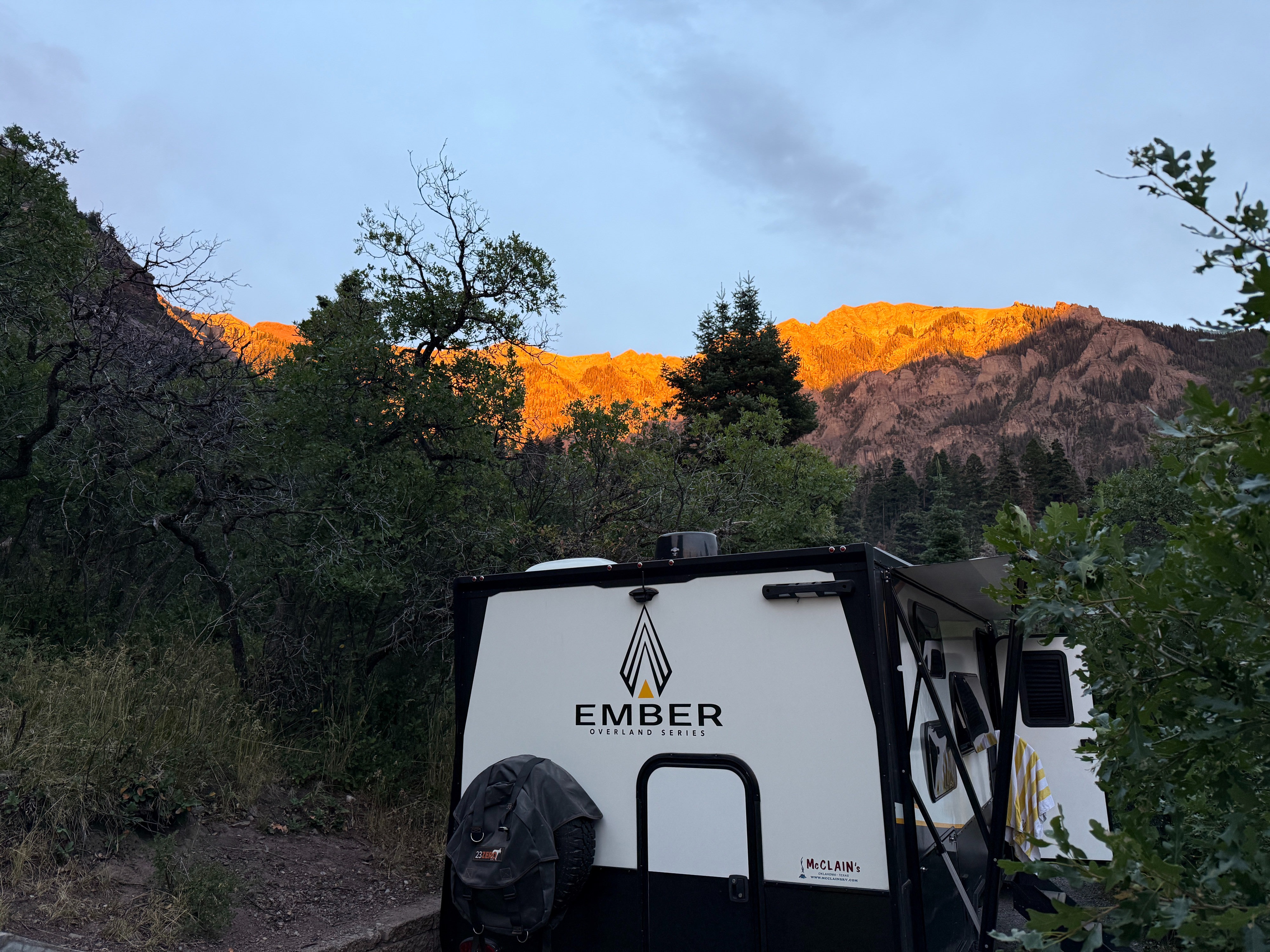 The Ember overlooking a sunlit mountain valley