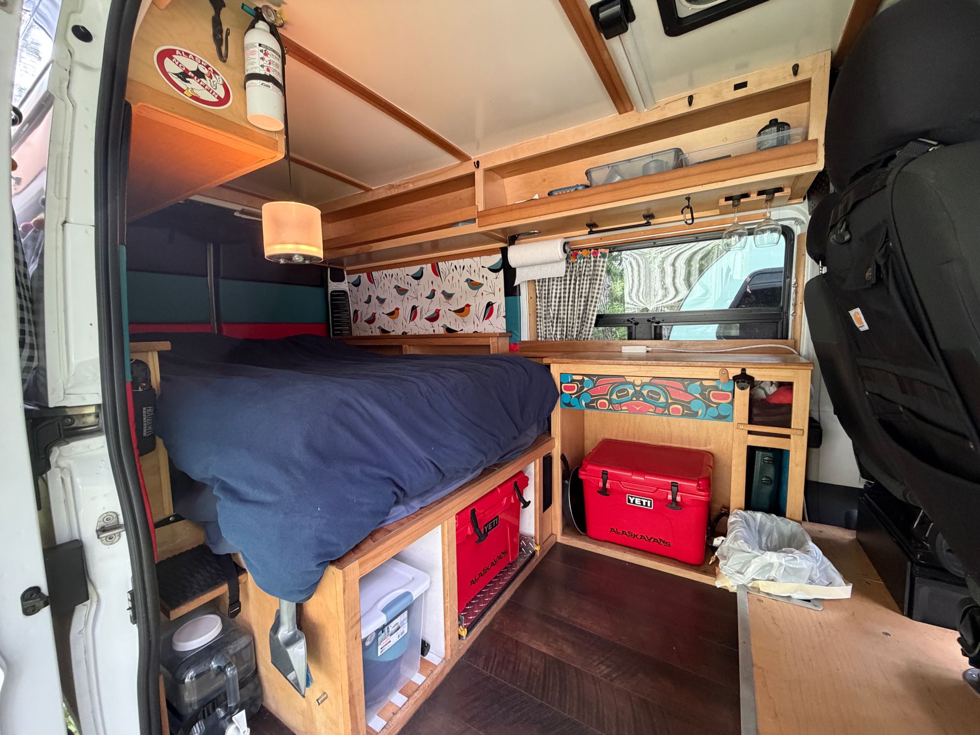 Compact camper van interior with bed, storage, and a red cooler, perfect for an RV rental adventure.. 3C6TRVBGXHE551668 Ram Pro Master Van 2017