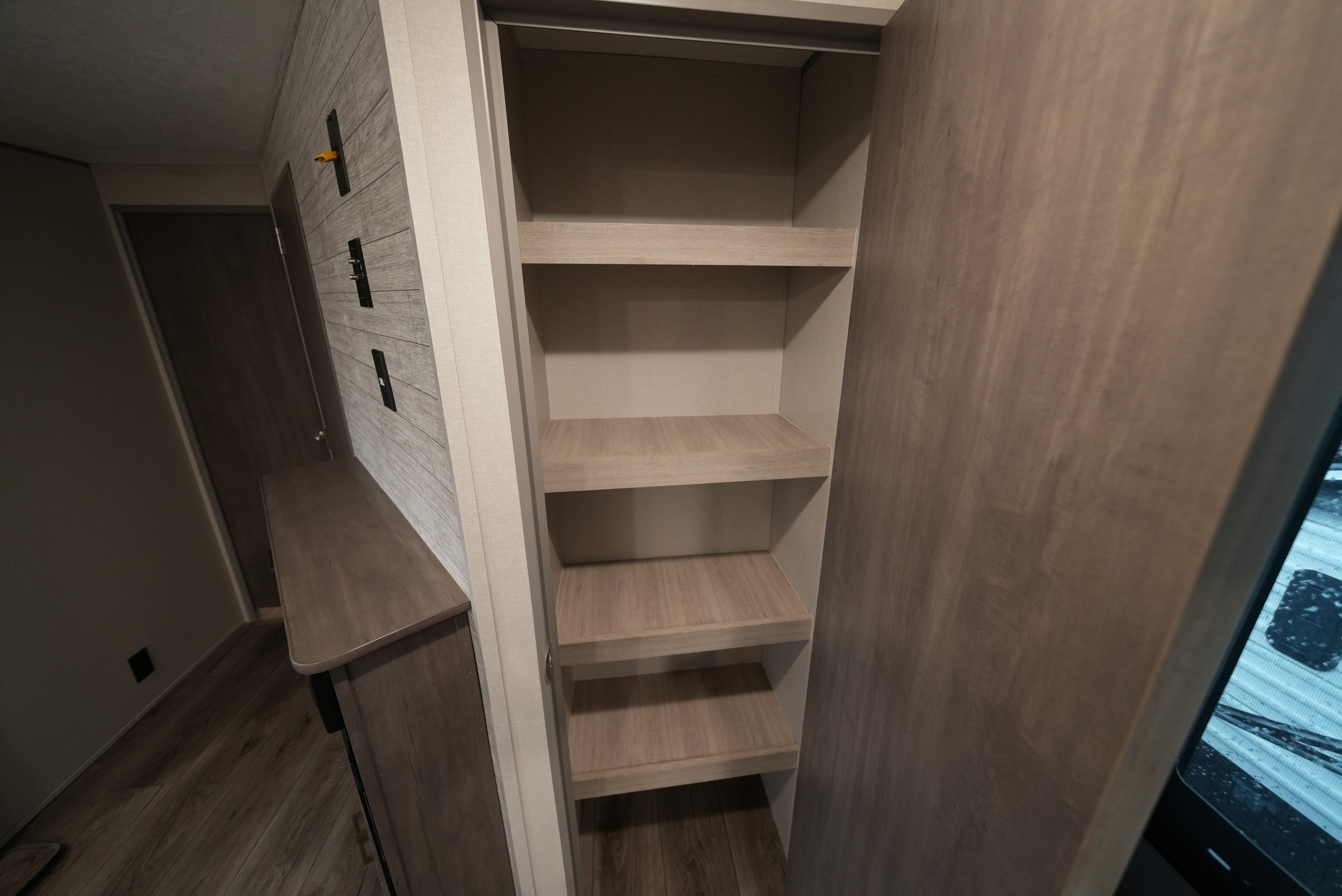 RV rental with functional interior storage: light wood shelves, wall mounts for electronics, and modern finishes.. Catalina 293TQBSCK 2025