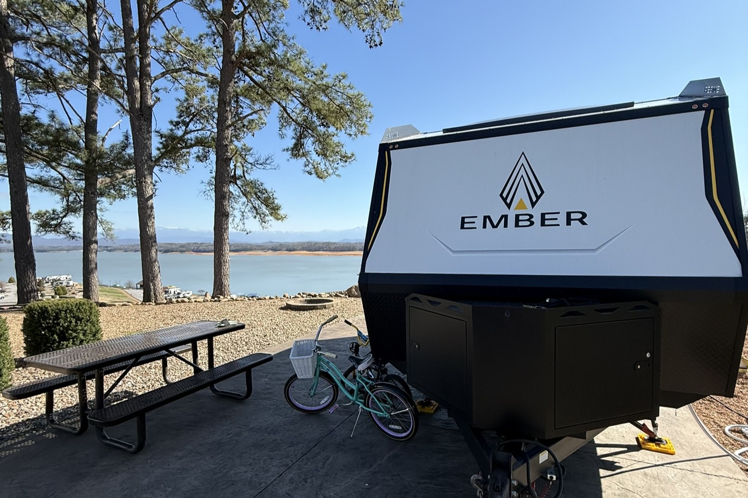 The Ember at a lakeside campsite with mountain views