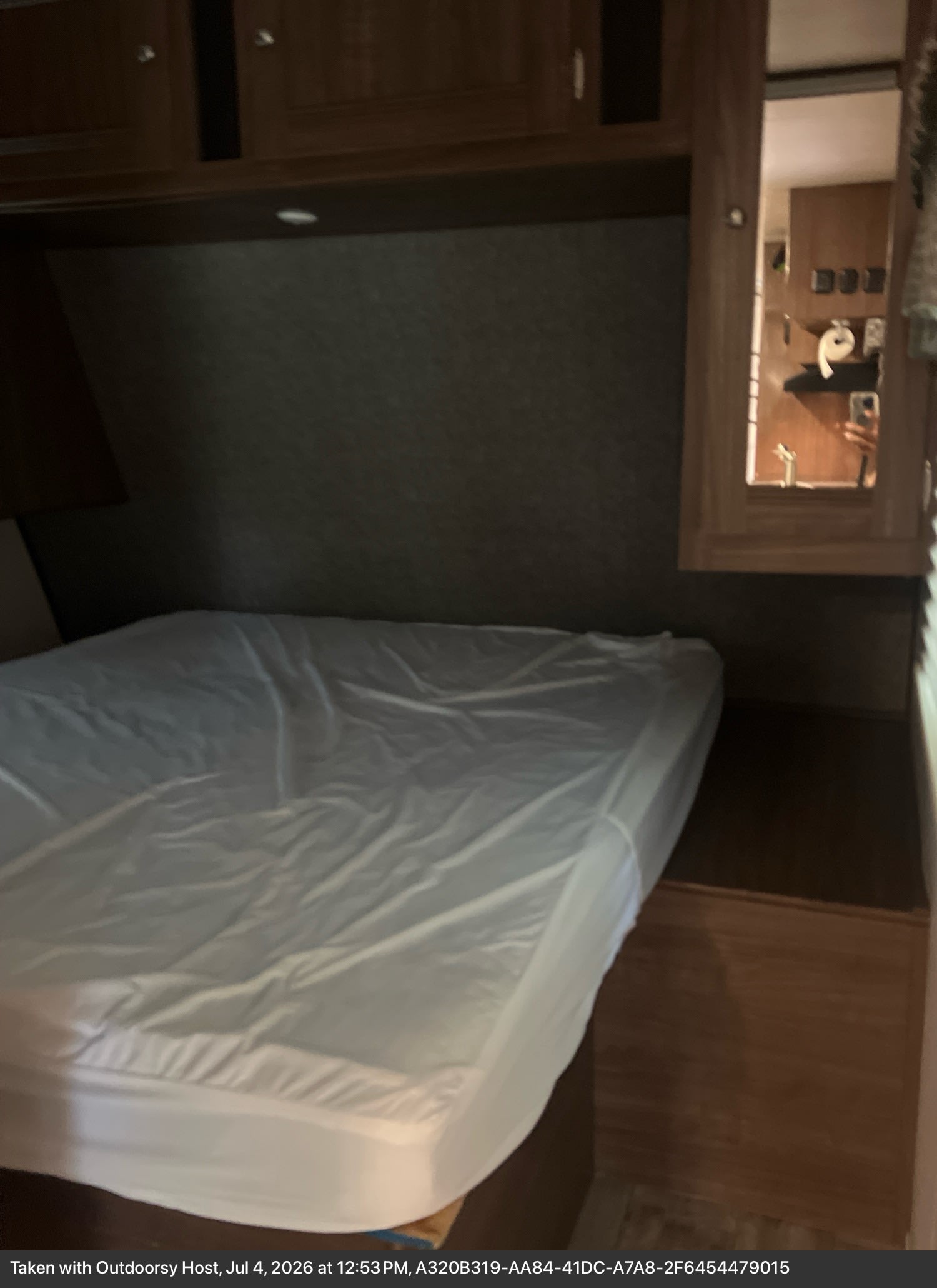 Cozy RV rental bedroom featuring a clean bed and ample overhead storage for a comfortable stay.. Heartland RVs Pioneer 2018