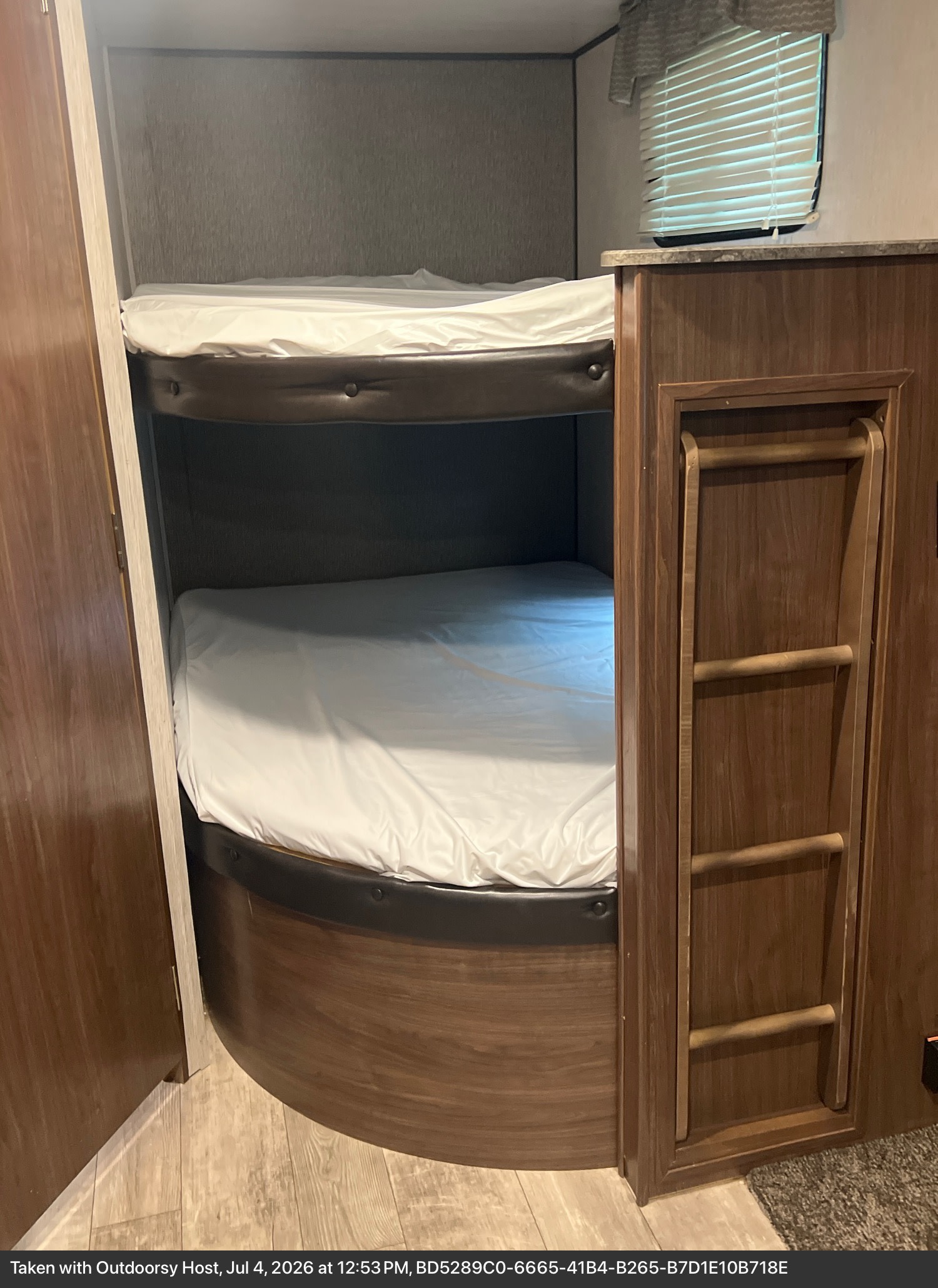 Comfortable bunk beds with a ladder for easy access in this RV rental's interior, ready for your next family adventure.. Heartland RVs Pioneer 2018