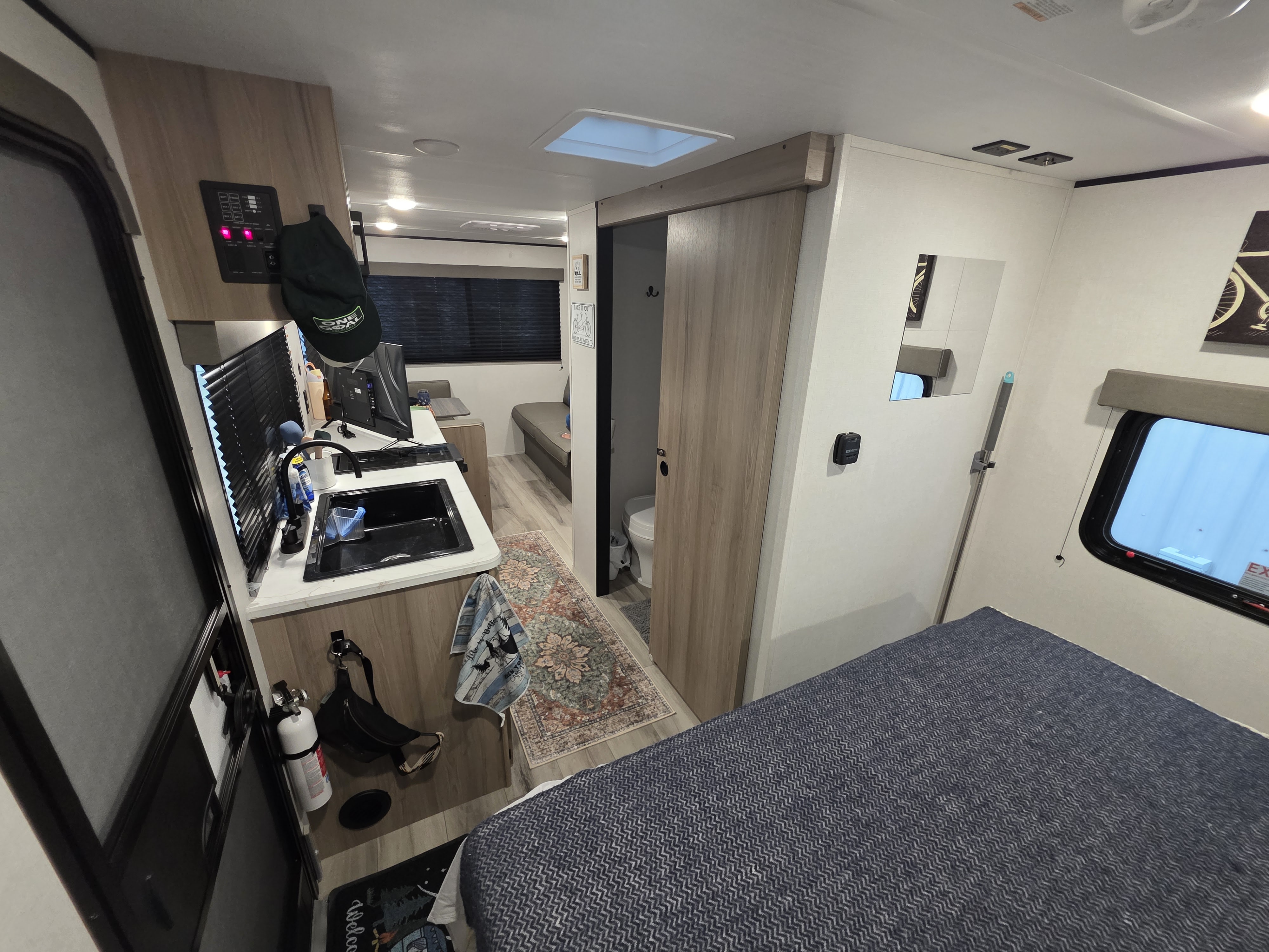 Inside this rv rental: a kitchen, dining nook, bed, and bathroom. Designed for comfortable travel adventures.. Keystone RV Coleman 2026